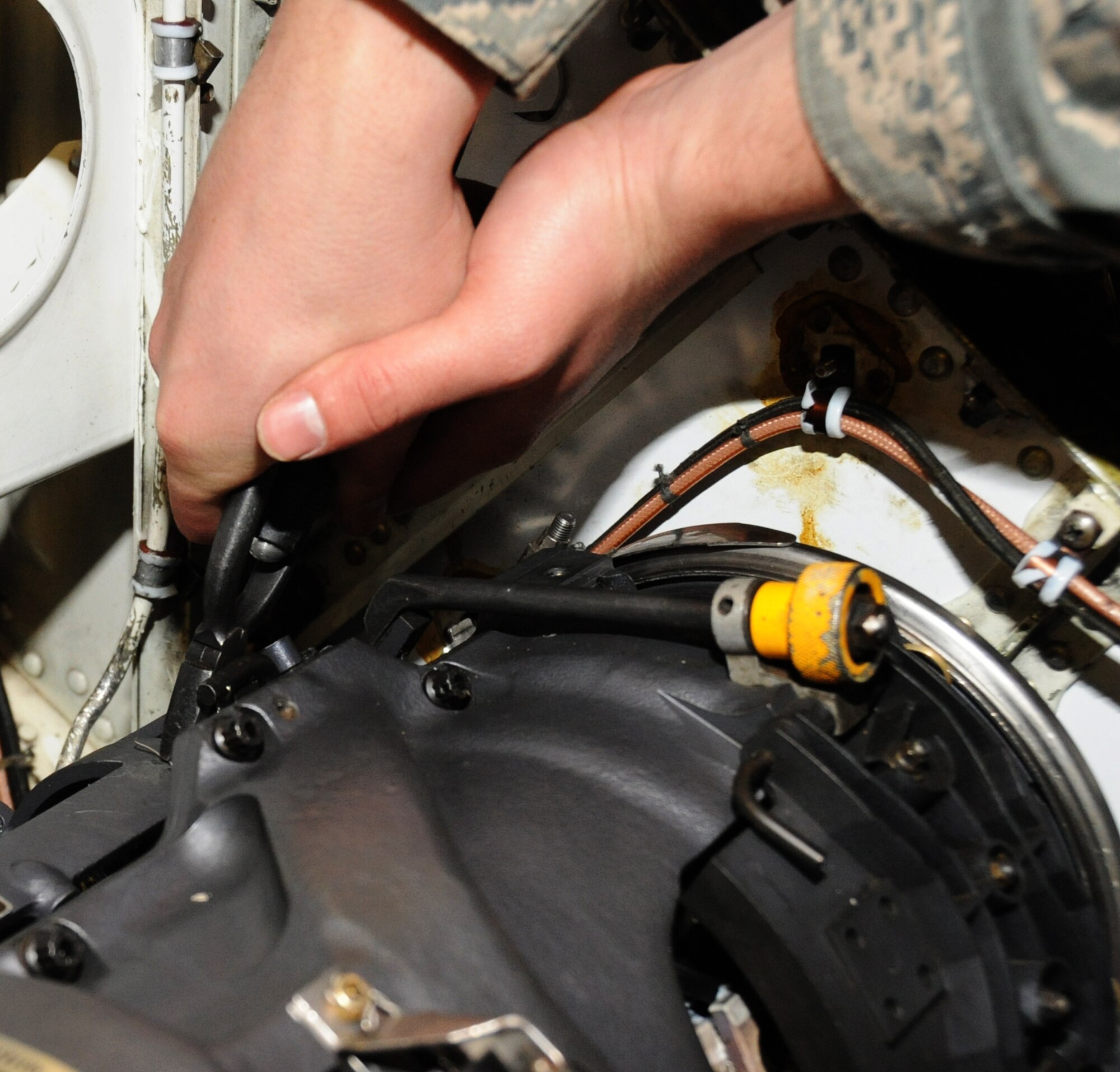 U.S. Air Force Airman 1st Class Joseph Thompson, 14th Aircraft Maintenance Unit weapons load crew member, adjusts slack on an M-61A1 20mm multi-barrel cannon on an F-16 Fighting Falcon aircraft at Misawa Air Base, Japan, Feb. 24, 2012. The AMUs armament Airmen must check the slack, if it is too loose or too tight the gun may malfunction when the pilot pulls the trigger. (U.S. Air Force photo by Airman Kenna Jackson/Released)