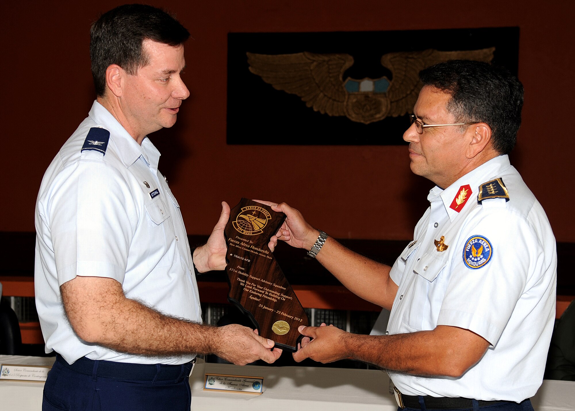 Colonel Gary Gottschall, 615th Contingency Response Wing commander, presents Brig. Gen. Ruiz Pastor Landa Dubón, Honduran air force commanding general, a plaque and thanks him for his hospitality and partnership between the two air forces following the opening ceremony in Tegucigalpa, Honduras, Feb. 23.  (U.S. Air Force photo by Tech. Sgt. Lesley Waters)