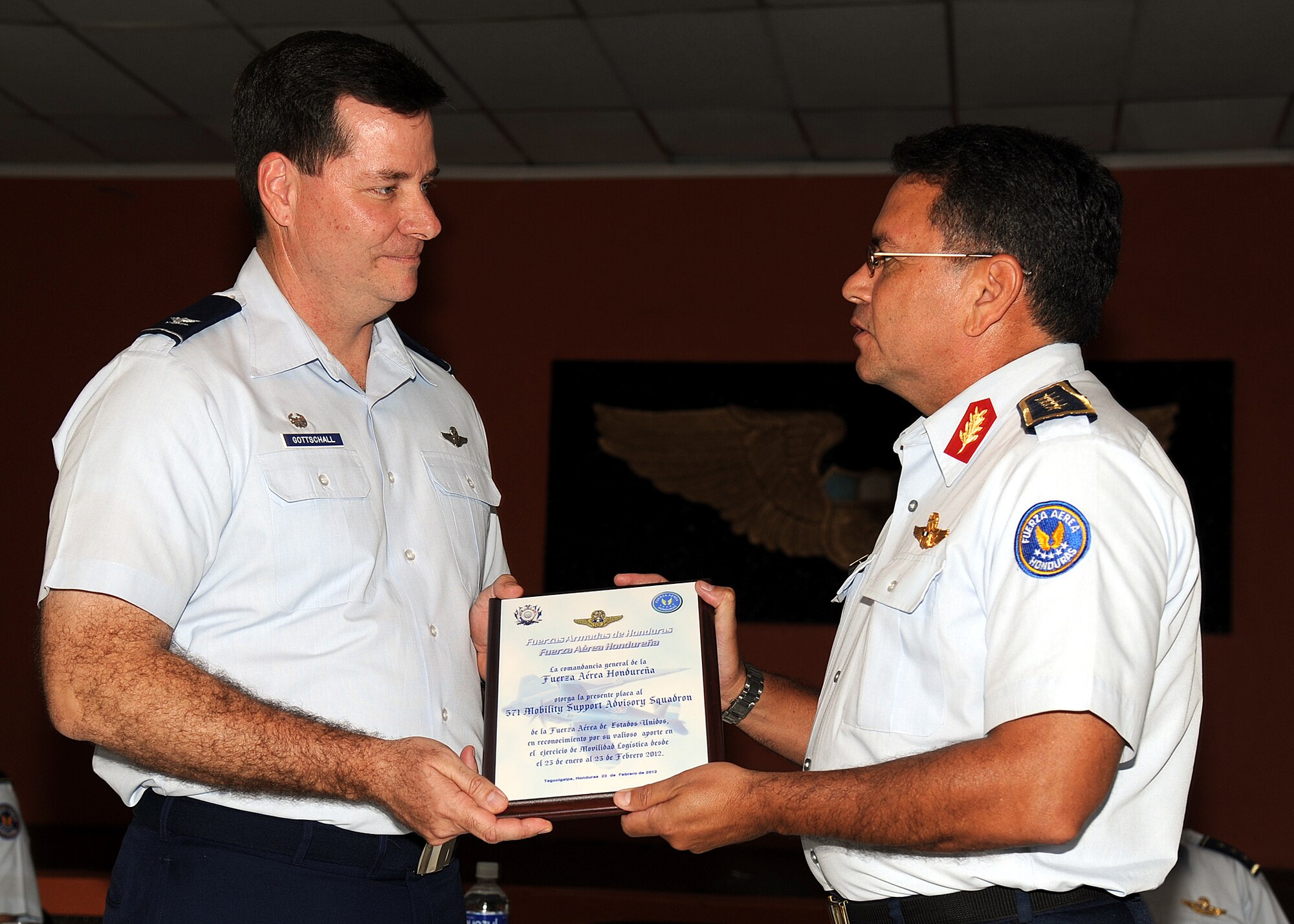 Brigadier Gen. Ruiz Pastor Landa Dubón, Honduran air force commanding general, presents Colonel Gary Gottschall, 615th Contingency Response Wing commander, a plaque and thanks him for the partnership between the two air forces during the closing ceremony in Tegucigalpa, Honduras, Feb. 23.  (U.S. Air Force photo by Tech. Sgt. Lesley Waters)