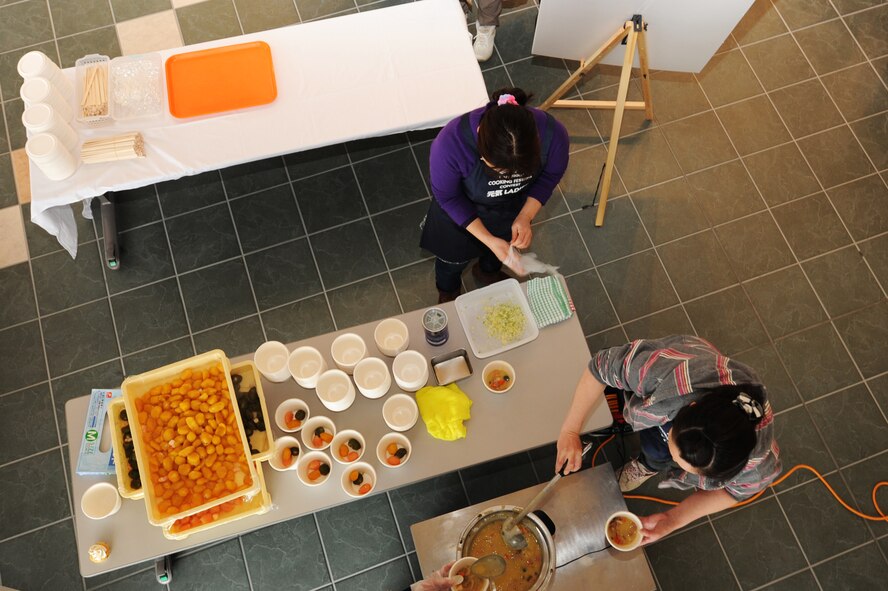 Members of the Genki Ladies team cook soup during the Japan-U.S. Exchange Festa at the Misawa International Center, Misawa City, Japan, Feb. 25, 2012. The Genki Ladies team made soy milk chowder, which contained vegetables harvested in Misawa and was based on an American chowder dish. (U.S. Air Force photo by Airman 1st Class Kia Atkins/Released)