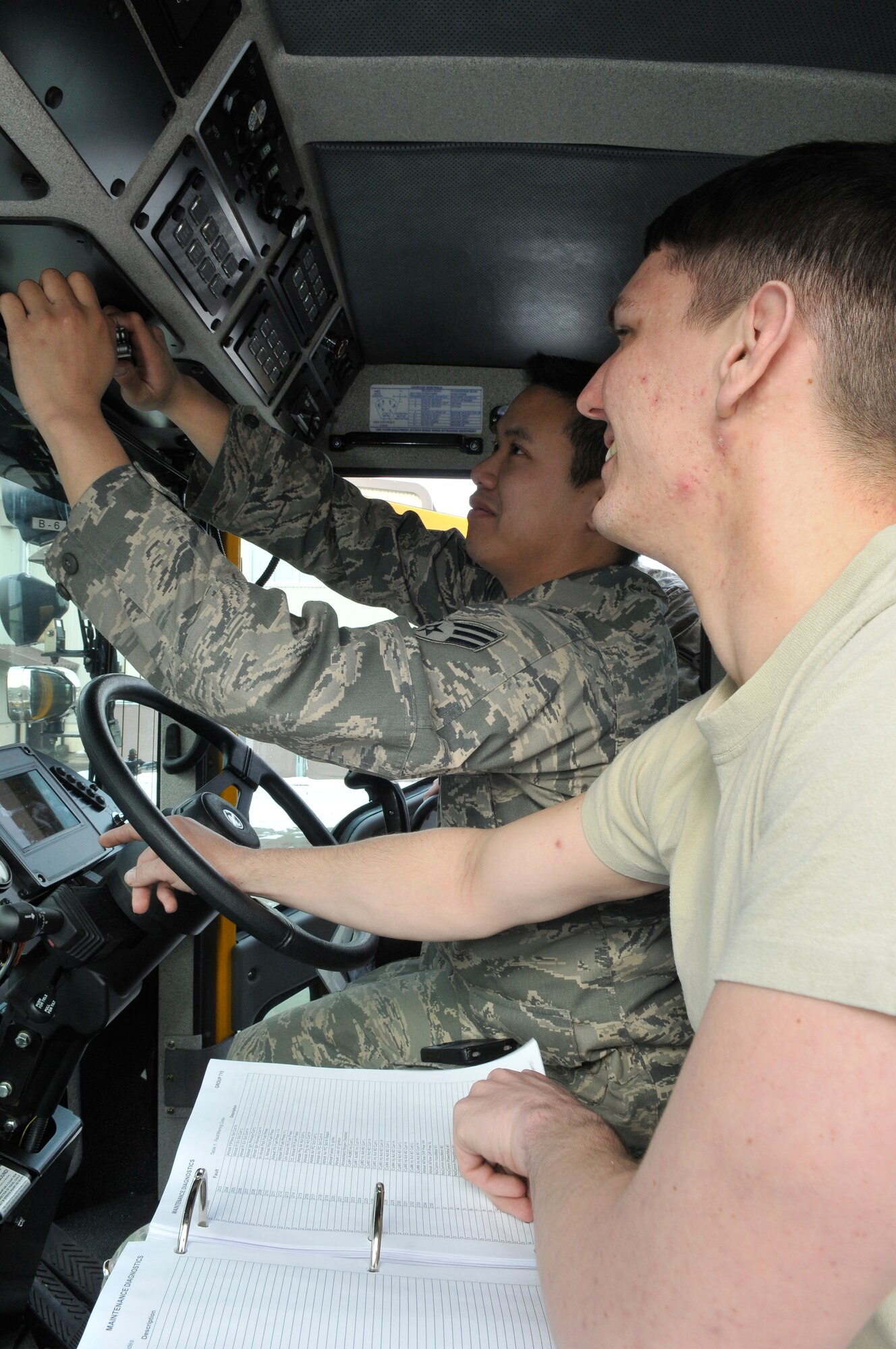 U.S. Air Force Senior Airman Anthony Nguyen, vehicle maintenance craftsman, checks the connections on an electrical panel, while U.S. Air Force Airman 1st Class Chad Berry, vehicle maintenance apprentice, looks for an indication on a display in an Oshkosh flightline snow blower at Misawa Air Base, Japan Feb. 27, 2012. Both Airmen maintain vehicles for the 35th Logistics Readiness Squadron Vehicle Maintenance Flight. (U.S. Air Force photo by Tech. Sgt. Phillip Butterfield/ Released)     