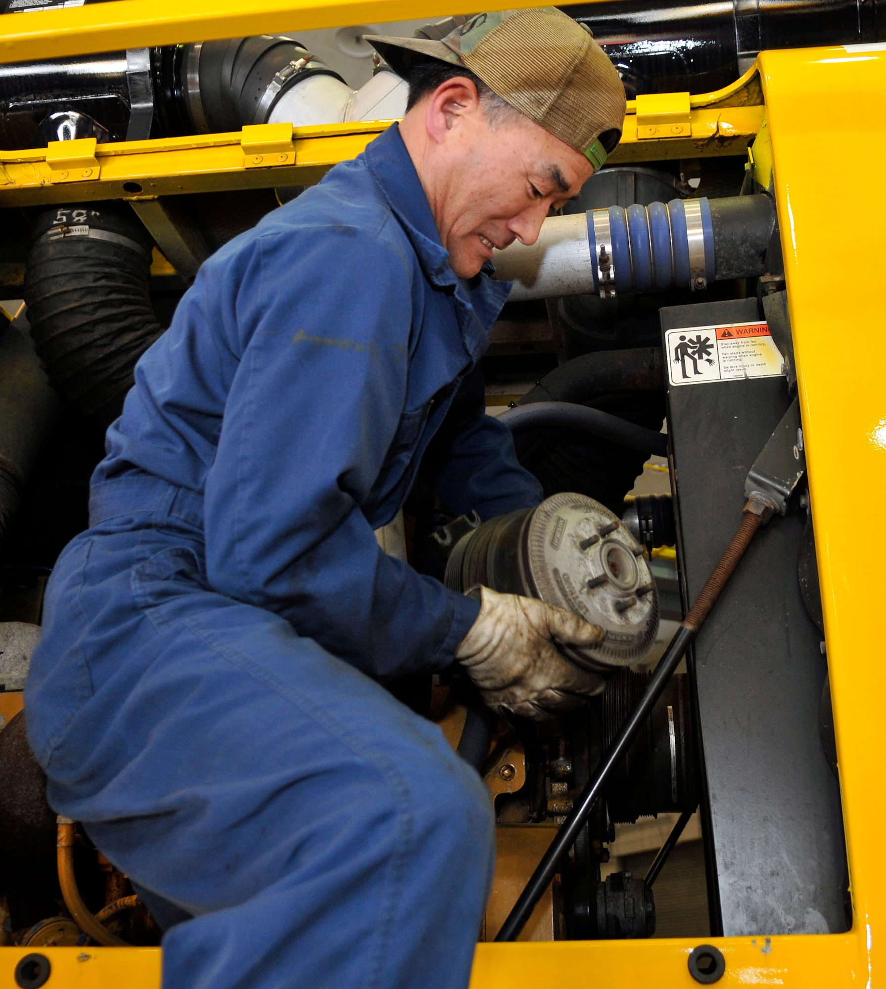 Sadao Sumomozawa, 35th Logistics Readiness Squadron Specialty Vehicle Maintenance Shop heavy duty vehicle mechanic, replaces a crankshaft pulley on an Oshkosh flightline snow blower in the SVMS at Misawa Air Base, Japan Feb. 27, 2012. The SVMS is one of several shops found in the 35 LRS Vehicle Maintenance Flight, which keeps Misawa’s vehicles running at their best. (U.S. Air Force photo by Tech. Sgt. Phillip Butterfield/ Released)     