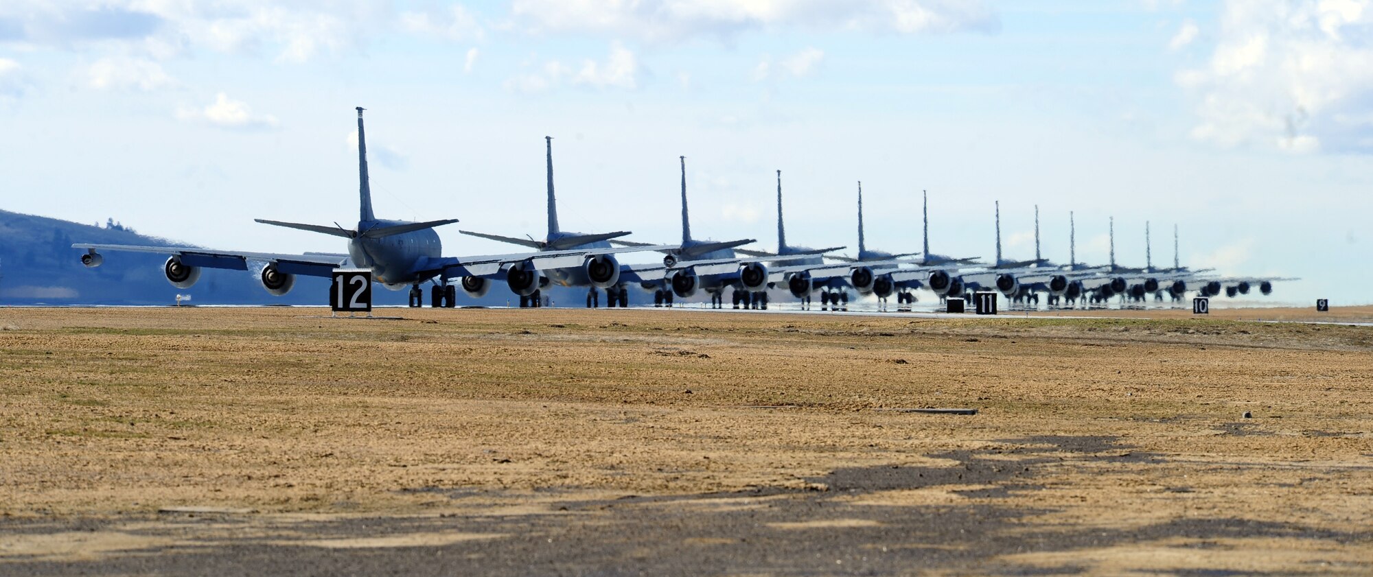 KC-135 Stratotanker refueling aircraft from Fairchild Air Force Base, Wash., taxi down the runway in an "Elephant Walk" during a training mission demonstrating total force integration Feb. 23, 2012. Personnel from the 92nd and 141st Air Refueling Wings executed the mission and launched several aircraft. "Elephant Walk" is a historic, uniquely-Air Force term that describes the nose-to-tail, single-file taxi movements of the aircraft synonymous with the nose-to-tail trail of lumbering elephants. (U.S. Air Force photo by Airman 1st Class Taylor Curry)