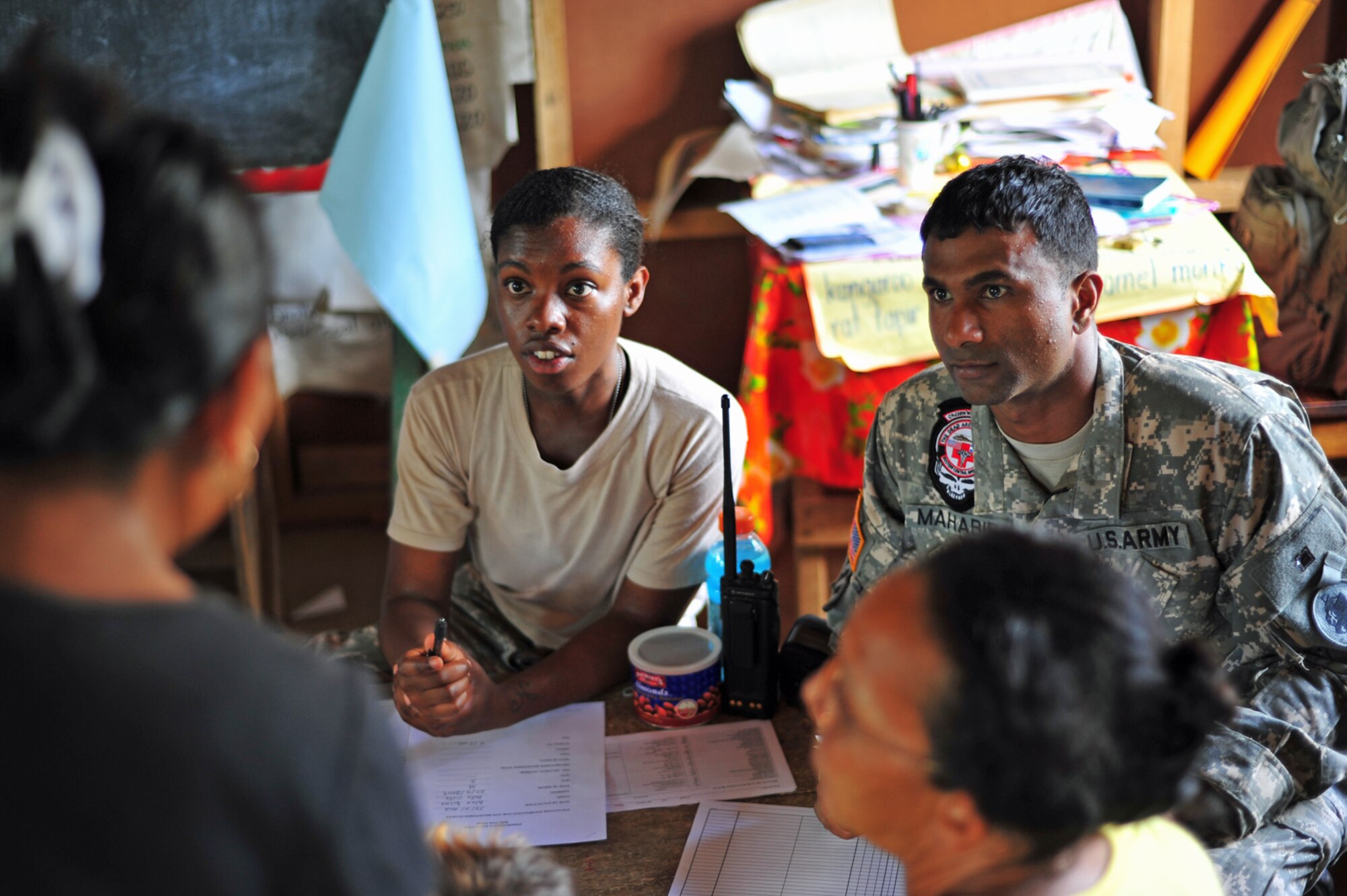 BELLA VISTA, Belize – U.S. Air Force Staff Sgt. Jefflynn Hall, Medical Element medical technician and Sgt. Chris Mahabir, 1st Battalion, 228th Aviation Regiment flight medic, conduct a screening for a Belizean family during the first day of a joint medical readiness training exercise here Feb. 28. In 2011, Joint Task Force Bravo, Soto Cano AB, Honduras provided general medical care to 14,401 patients and dental care to 1,061 patients for a total of 15,462 individuals receiving much-needed assistance. (U.S. Air Force photo/Staff Sgt. Bryan Franks)