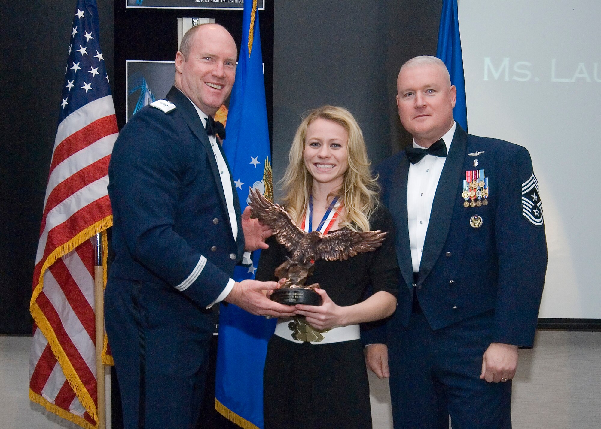 Air Force Flight Test Center Student Trainee of the Year, Lauren Kern, 412th Test Wing, receives her award from Brig. Gen. Robert C. Nolan II, commander, AFFTC and Chief Master Sgt. Bill Thomaston, command chief, 95th Air Base Wing, during the 2011 AFFTC Annual Awards Banquet, Feb. 24. (U.S. Air Force Photo by Rob Densmore)