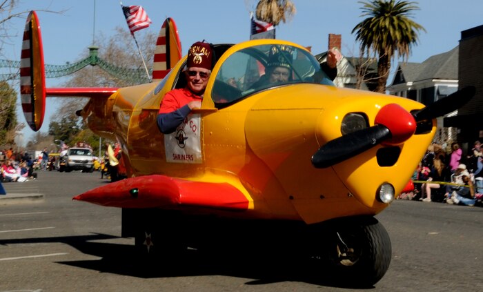 Members of the Ben Ali Shriners Club fly by in a motorized airplane car in Marysville, Calif., Feb 25, 2012. The Bok Kai parade is held every year and features a variety of floats and cultural performances. (U.S. Air Force photo by Senior Airman Sandra Healy)