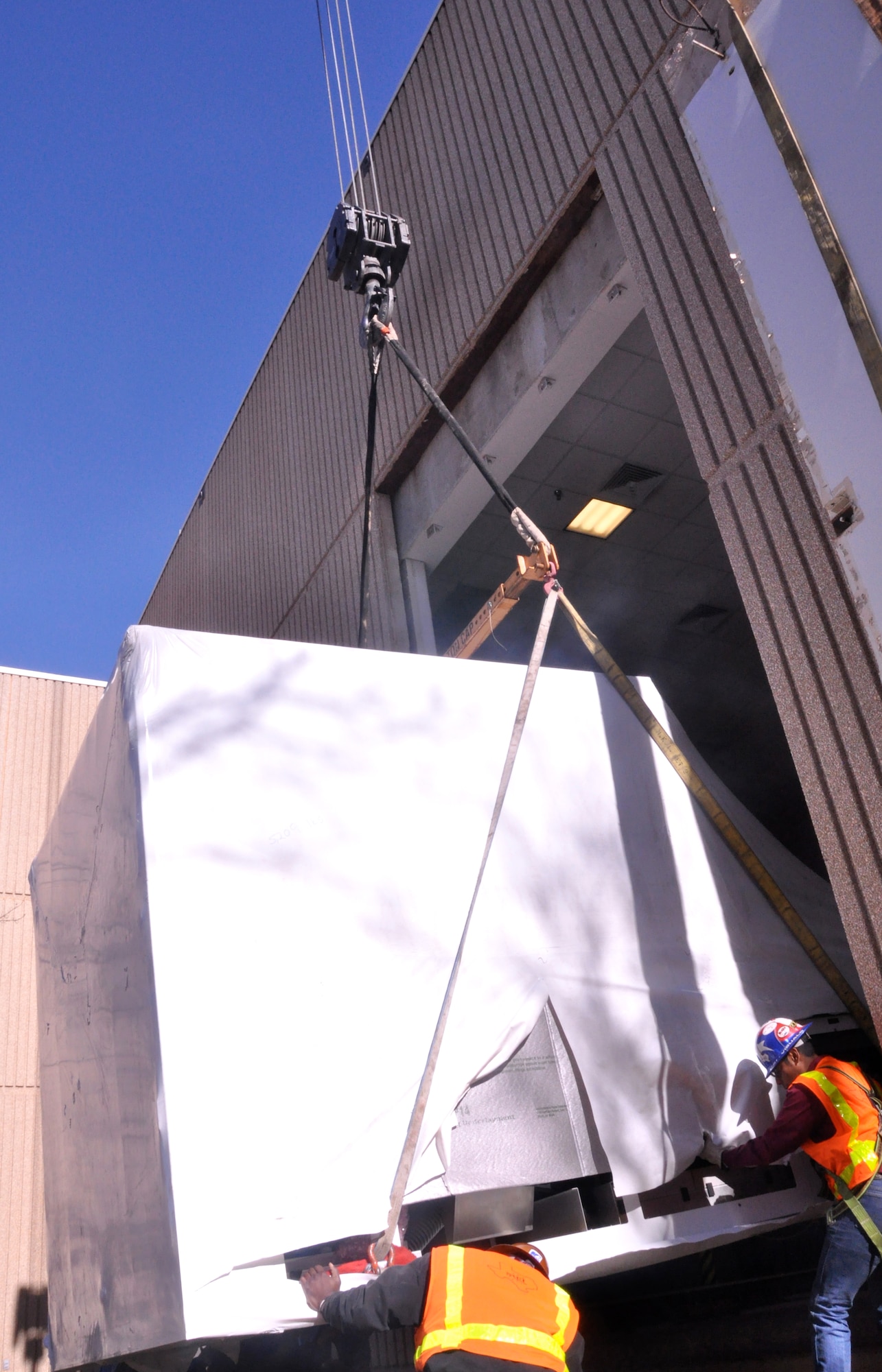 A new T-1A Jayhawk flight simulator, built by the L-3 Communications company, is lifted through the side of the 71st Operations Group building Feb. 22 at Vance Air Force Base, Okla., by a crane from Taylor Crane Rigging in Coffeyville, Kan. The simulator is the second Vance has received from L-3. (U.S. Air Force photo/ Airman 1st Class Frank John Casciotta)