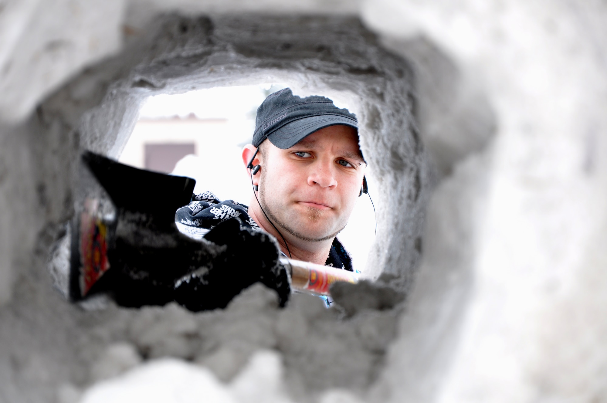 Kyle Slivnik, 319th Civil Engineer Squadron base community planner, works on a snow sculpture Feb. 22, 2012, on Grand Forks Air Force Base, N.D. The sculpture was a four-sided snowman silhouette and was submitted as an entry for the Iceman Competition during the base's annual Winter Bash on Feb. 23, 2012. (U.S. Air Force photo/Airman 1st Class Derek VanHorn)