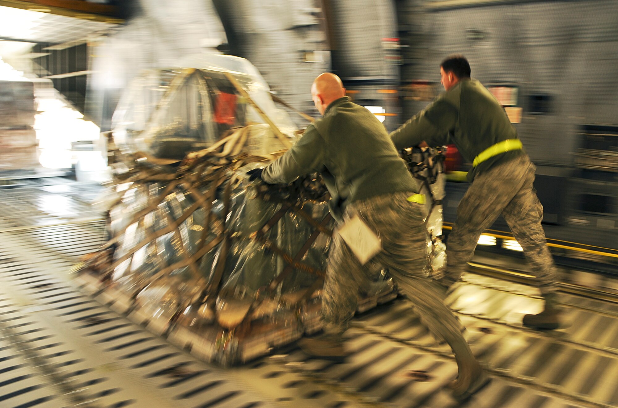 Members of the 436th Aerial Port Squadron off-load cargo pallets from a C-17 Globemaster III, Feb. 10, 2012, at Dover Air Force Base, Del. (U.S. Air Force photo by Master Sgt. Jeanette Spain)