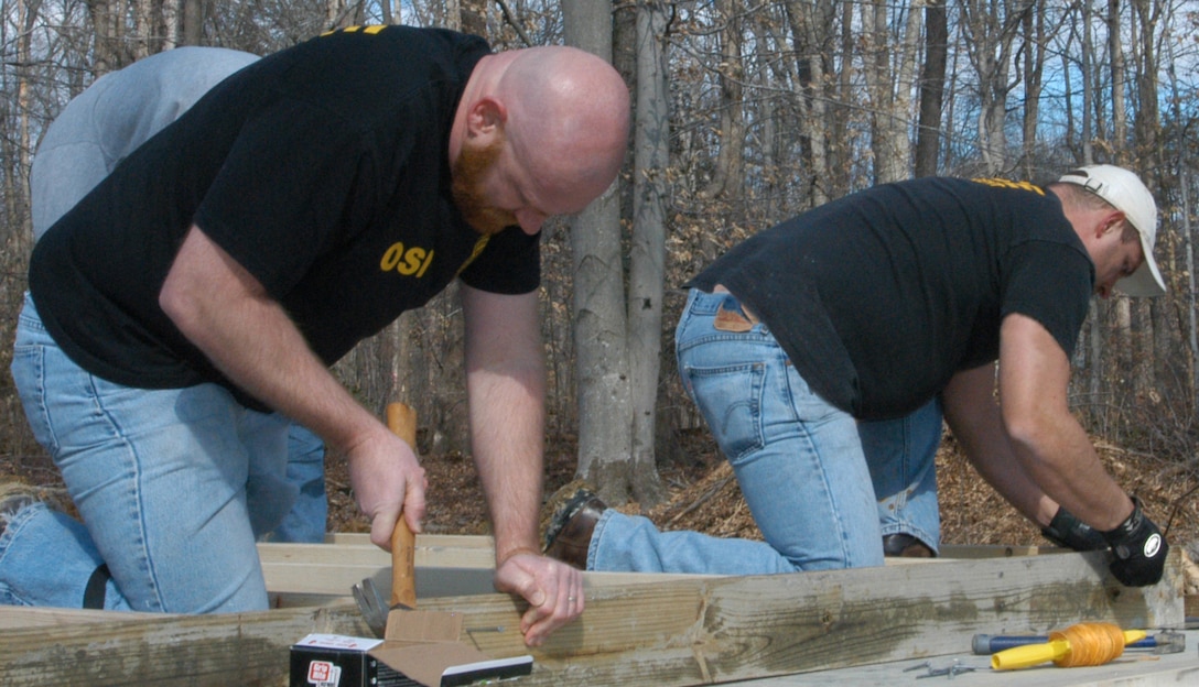 OSI agents help secure the foundation for the next wall during a Habitat for Humanity project Feb. 23. OSI Headquarters members spent the day working on the home in Stafford, Va. (U.S. Air Force photo by Mr. James C. Dillard.)