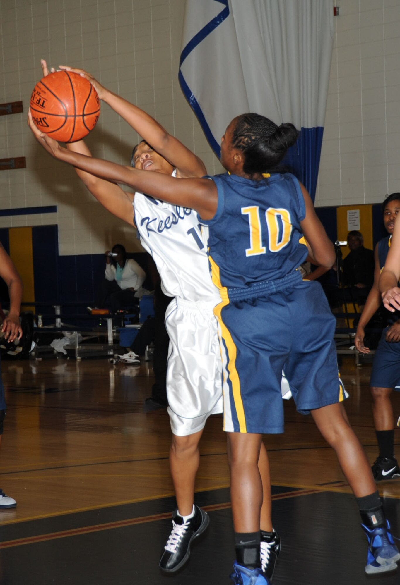 Lady Dragon Tomeika Washington and Mayport’s Erica Sims stretch for a loose ball during a Southeastern Military Athletic Conference Women’s basketball tournament game Feb. 25, 2012, in the Blake Fitness Center at Keesler Air Force Base, Miss. Naval Station Mayport defeated Keesler 56-49. Keesler finished 3rd place in the tournament.  (U.S. Air Force photo by Kemberly Groue)