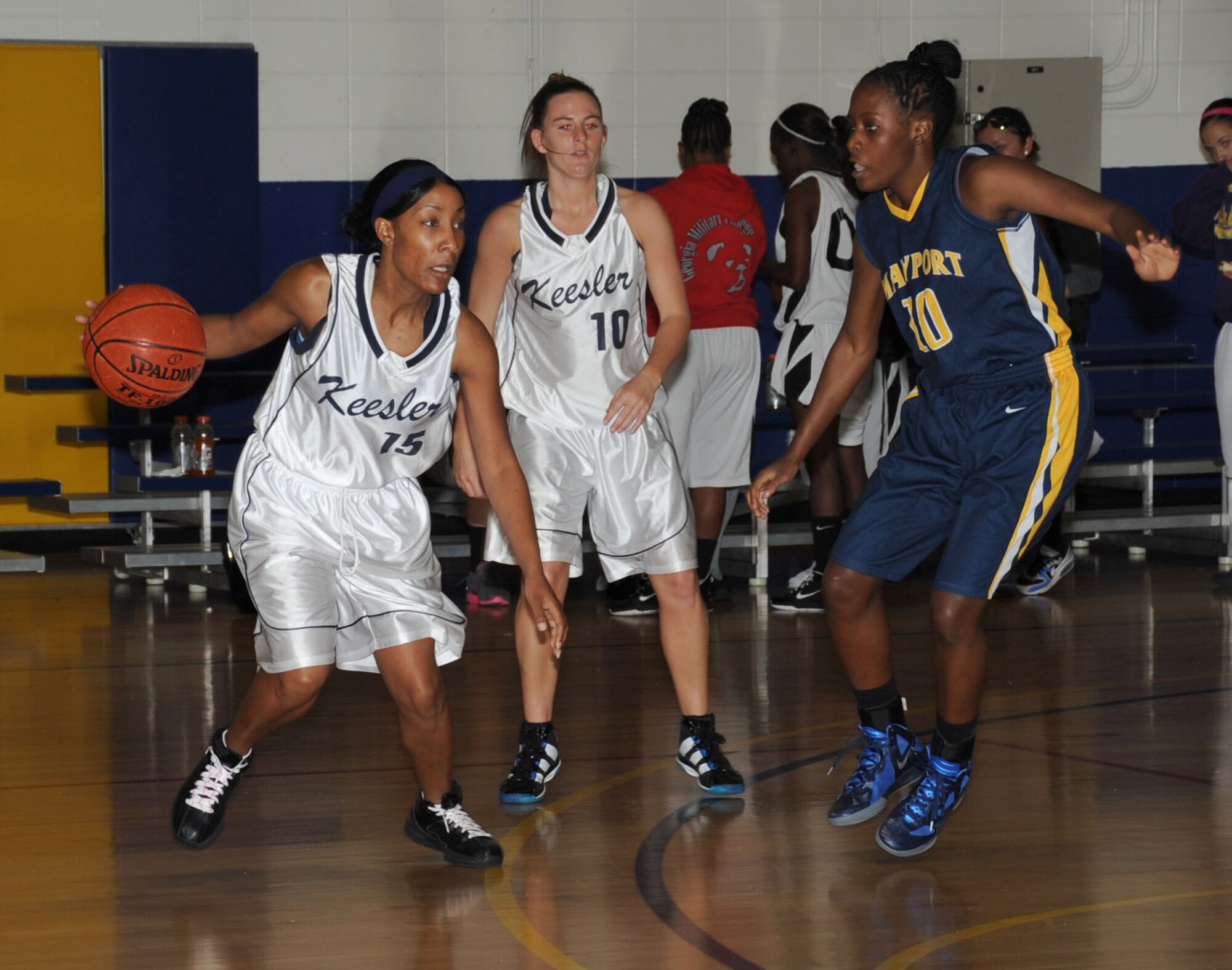 Lady Dragons’ Tomeika Washington and Brittany Deichmann move the ball around the court as Mayport’s Erica Sims plays defense during a Southeastern Military Athletic Conference Women’s basketball tournament game Feb. 25, 2012, in the Blake Fitness Center at Keesler Air Force Base, Miss. Naval Station Mayport defeated Keesler 56-49. Keesler finished 3rd place in the tournament.  (U.S. Air Force photo by Kemberly Groue)
