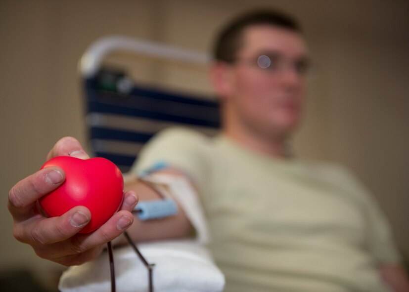 HOLLOMAN AIR FORCE BASE, N.M. -- Senior Airman Aaron Dickerson, 49th Civil Engineer Squadron, squeezes a stress-relief ball during an Armed Services Blood Drive Feb. 24, at the Community Activity Center. The blood collected from the drive will go directly to the overseas war fighters and military treatment facilities in the U.S. and abroad. (U.S. Air Force photo by Tech. Sgt. Joe Laws/Released)