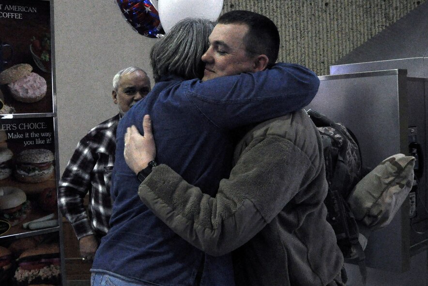 Tech. Sgt. Joel Keltner, 442nd Civil Engineers Squadron utility superintendent,  receives a hug after returning home from a six-month deployment to Afghanistan. The 442nd CES is part of the 442nd Fighter Wing, an A-10 Thunderbolt II Air Force Reserve unit at Whiteman AFB, Mo. (U.S. Air Force photo/Senior Airman Wesley Wright)