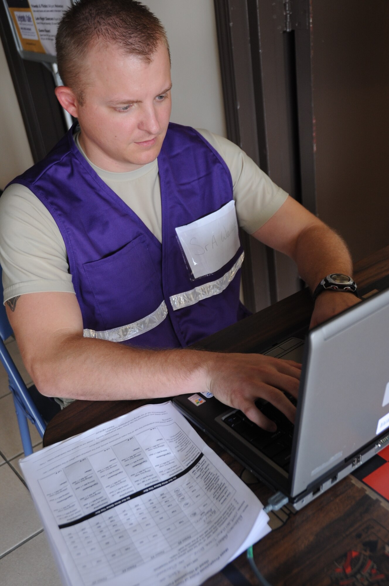 Senior Airman Ryan Wallace, 81st Aerospace Medicine Squadron, signs in patients electronically during a disease contaminant plan exercise Feb. 23, 2012, at the Vandenburg Community Center, Keesler Air Force Base, Miss.  (U.S. Air Force photo by Kemberly Groue)