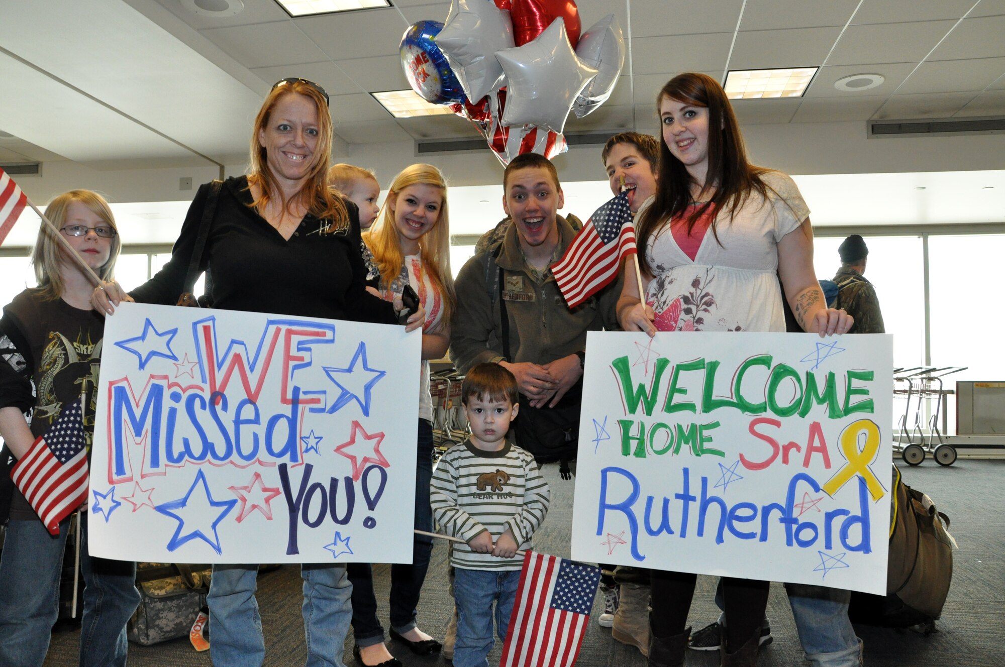 Senior Airman Jeremy Rutherford, 442nd Civil Engineers Squadron, poses with family after returning home from a six-month deployment to Afghanistan. The 442nd CES is part of the 442nd Fighter Wing, an A-10 Thunderbolt II Air Force Reserve unit at Whiteman AFB, Mo. (U.S. Air Force photo/Senior Airman Wesley Wright)