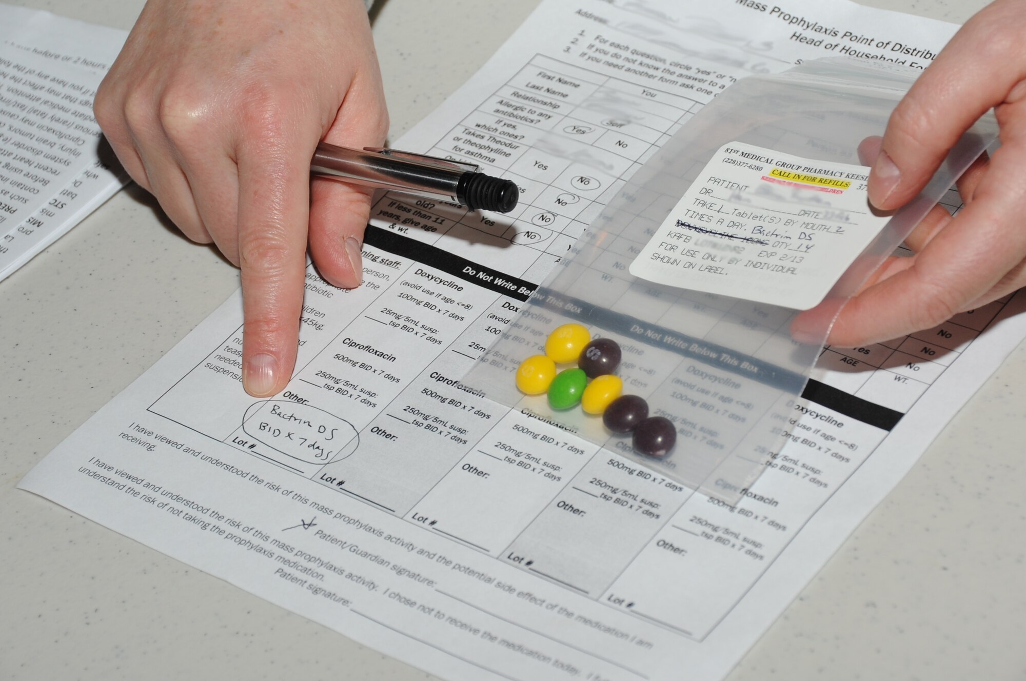 Major Christa Sechrist, 81st Diagnostics and Therapeutics Squadron, provides patient consultation on a prescription given during a disease contaminant plan exercise Feb. 23, 2012, at the Vandenburg Community Center, Keesler Air Force Base, Miss.  (U.S. Air Force photo by Kemberly Groue)