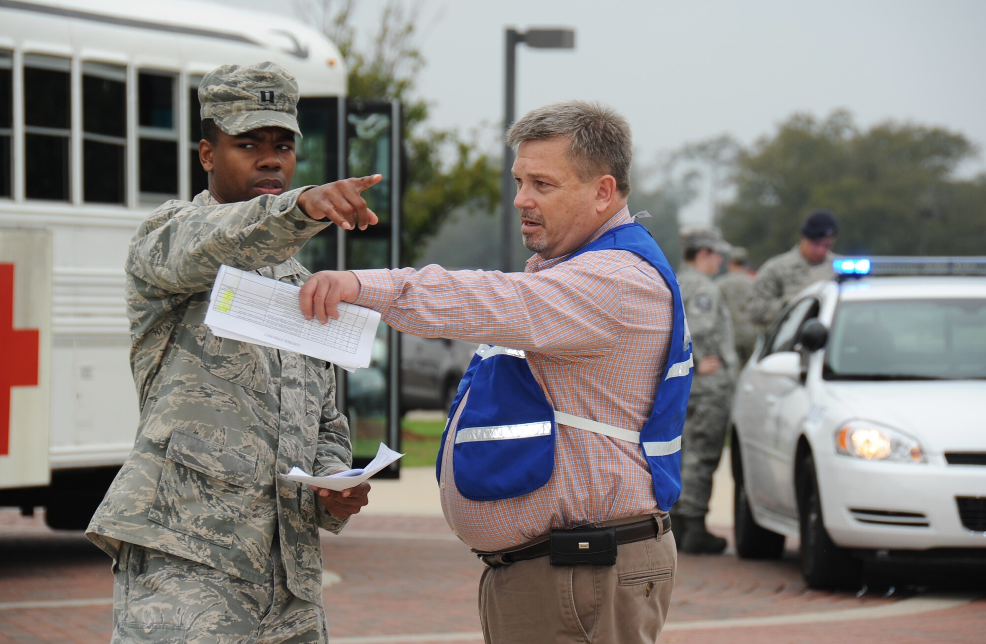 Capt. Brandon Shealey , 81st Medical Support Squadron team chief for patient administration, and Robert Tash 81st MDSS emergency management coordinator, direct the patient administration area during a disease contaminant plan exercise Feb. 23, 2012, at the Vandenburg Community Center, Keesler Air Force Base, Miss.   (U.S. Air Force photo by Kemberly Groue)