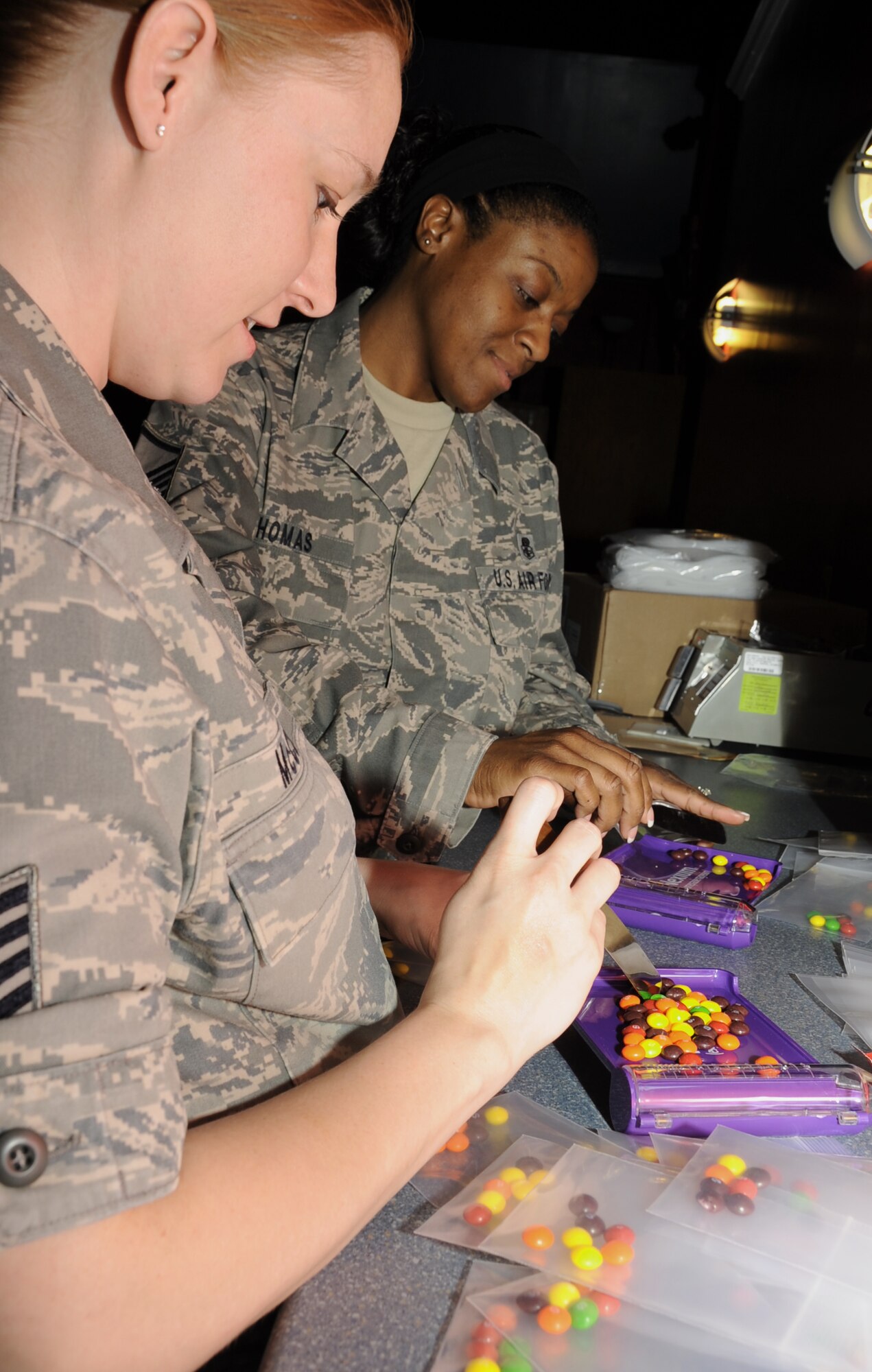 Tech. Sgt. Holly McCune and Master Sgt. Tasha Thomas, 81st Diagnostics and Therapeutics Squadron, sort candy that represents prescription drugs to be given out to “patients” during a disease contaminant plan exercise Feb. 23, 2012, at the Vandenburg Community Center, Keesler Air Force Base, Miss.  (U.S. Air Force photo by Kemberly Groue)