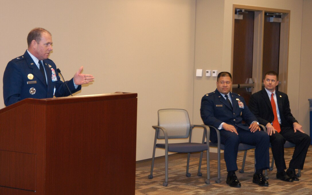 Lt. Col. (SA) Vasaga Tilo, left, and OSI Special Agent Andrew Schad listen to Brig. Gen. Kevin Jacobsen, OSI commander, give the introduction to their Bronze Star Medal ceremony Feb. 23. Both Colonel Tilo and SA Schad received the medal for their work while deployed to Afghanistan and Iraq, respectively. (U.S. Air Force photo by Mr. James C. DIllard.) 