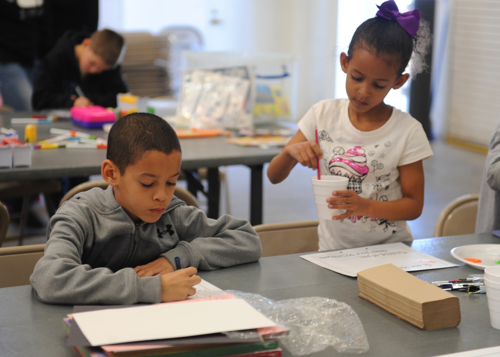 Bradyn and Mycala Reed, paint cards for deployed Airmen from the 7th Munitions Squadron, Feb. 25, 2012, at Dyess Air Force Base, Texas. Children and spouses made care packages for Airmen currently deployed to Southwest Asia. (U.S. Air Force photo by Airman 1st Class Cierra Bullock/Released)