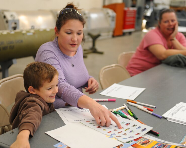 Tabatha Thompson and her son color pictures for their deployed loved one, Feb. 25, 2012, at Dyess Air Force Base, Texas. Thompsons’ spouse, U.S. Air Force Senior Airman Kevin Thomas, 7th Munitions Squadron, is currently deployed to Southwest Asia. (U.S. Air Force photo by Airman 1st Class Cierra Bullock/Released)