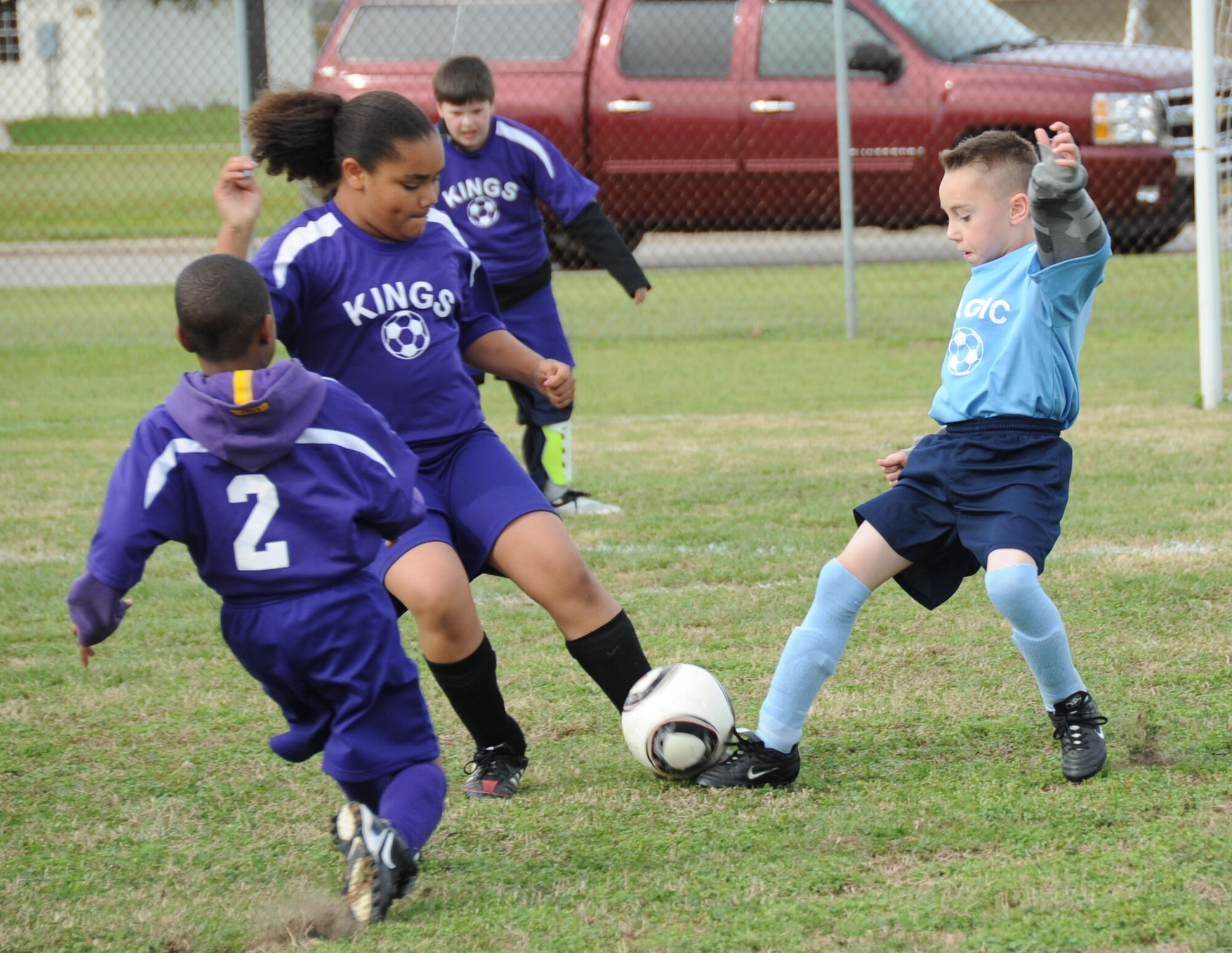 Ilycia Perez, 10, and Deiondre Holmes, 8, scramble for the ball against Austin Blankenship, 9, during a game between the Kings and Magic eight-to-ten year old youth soccer game Feb. 25, 2012, on the fields behind the Youth Center, Keesler Air Force Base, Miss.  Ilycia’s parents are Natasha and Airman 1st Class Matthew Wilson, 338th Training Squadron.  Deiondre’s parents are Inez and Staff Sgt. Quan Holmes, 81st Training Support Squadron.  Austin’s parents are Hope and Tech. Sgt. Daniyel Blankenship, 81st Infrastructure Division.  (U.S. Air Force photo by Kemberly Groue)