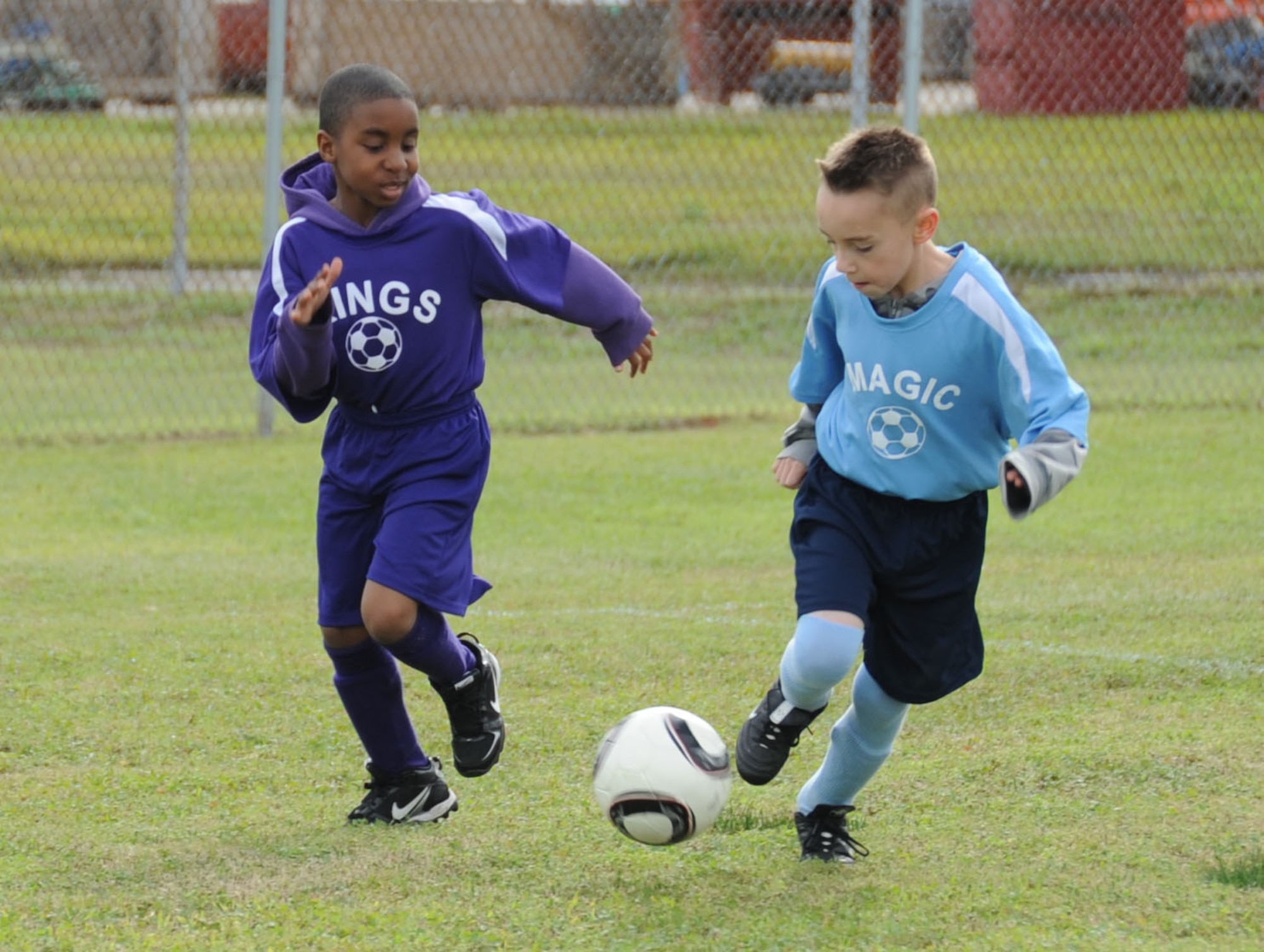 Deiondre Holmes, 8, son of Inez and Staff Sgt. Quan Holmes, 81st Training Support Squadron, chases Austin Blankenship, 9, son of Hope and Tech. Sgt. Daniyel Blankenship, 81st Infrastructure Division, during a game between the Kings and Magic eight-to-ten year old youth soccer game Feb. 25, 2012, on the fields behind the Youth Center, Keesler Air Force Base, Miss.  (U.S. Air Force photo by Kemberly Groue)