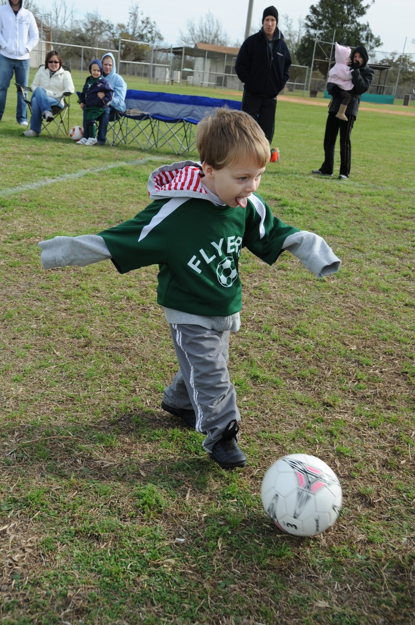 Three-year-old Jude Barber, Flyers, son of Lindsay and Staff Sgt. Isaac Barber, 334th Training Squadron, kicks the ball down the field during a youth soccer game against the Kings, Feb. 25, 2012, on the fields behind the Youth Center, Keesler Air Force Base, Miss.  (U.S. Air Force photo by Kemberly Groue)