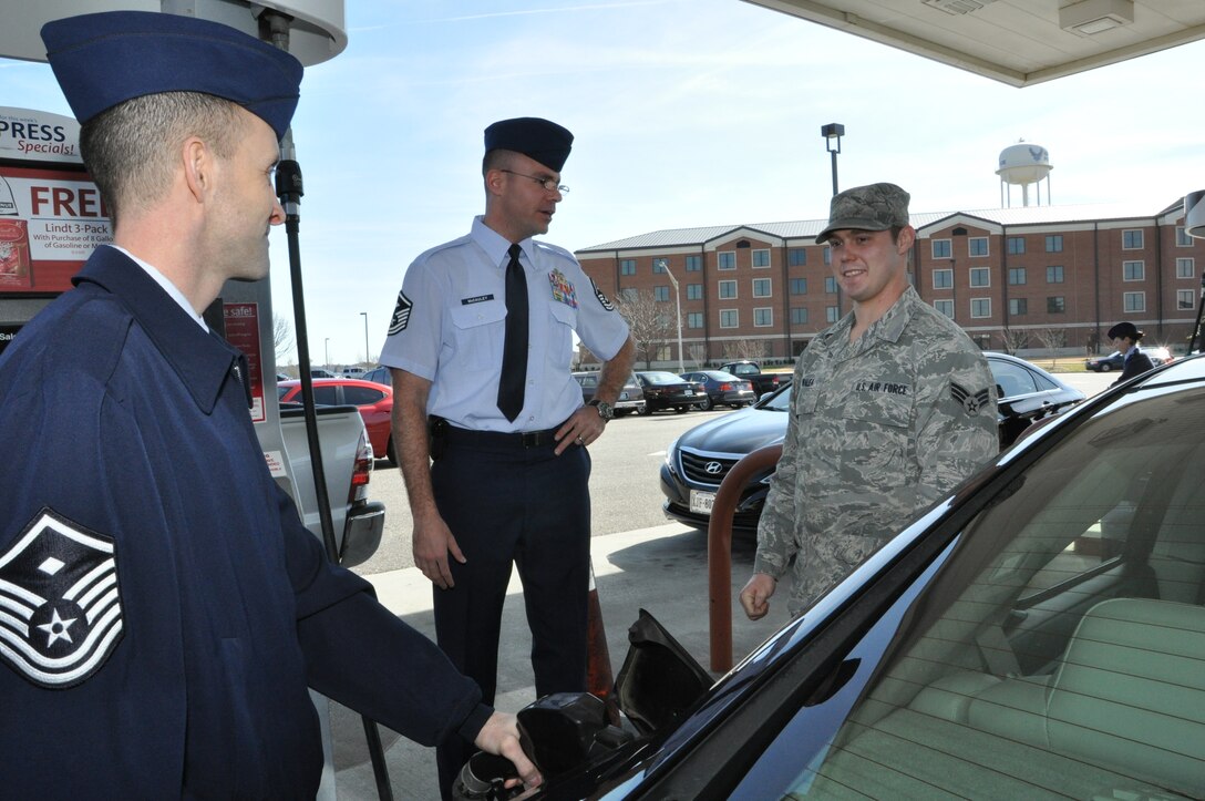 Master Sgt. Rob Mediavilla, 633rd Medical Group first sergeant, left, pumps a free tank of gas for Senior Airman James Walea, 1st Maintenance Squadron mechanic, at the gas station Feb. 27, 2012, at Langley Air Force Basse, Va. Master Sgt. Ryan McCauley, 633rd Air Base Wing staff agencies’ first sergeant, center, explains the details of the Random Acts of Kindness Program, and why the First Sergeant’s Council gave away $1,000 in gas. (U.S. Air Force Photo by Tech. Sgt. Randy Redman/Released)