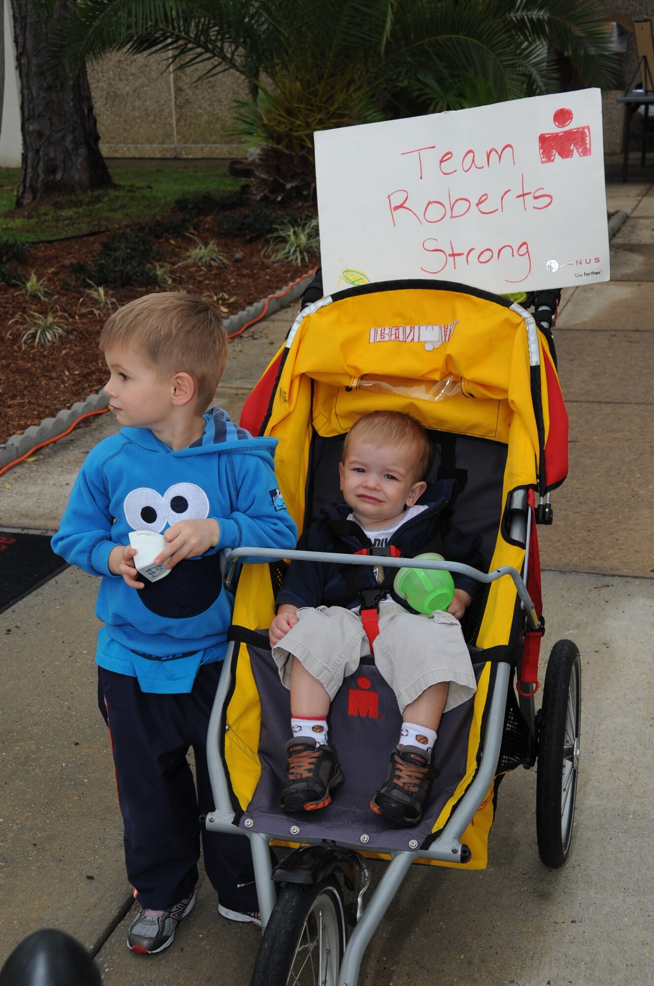 By the watchful eye of an adult friend, James Roberts, 3, and his younger brother Daniel, 1, watch their parents, Katy and Mark Roberts, 81st Dental Squadron, participate in the 5 K heart run/walk Feb. 24, 2012, at the Blake Fitness Center, Keesler Air Force Base, Miss.   (U.S. Air Force photo by Kemberly Groue)