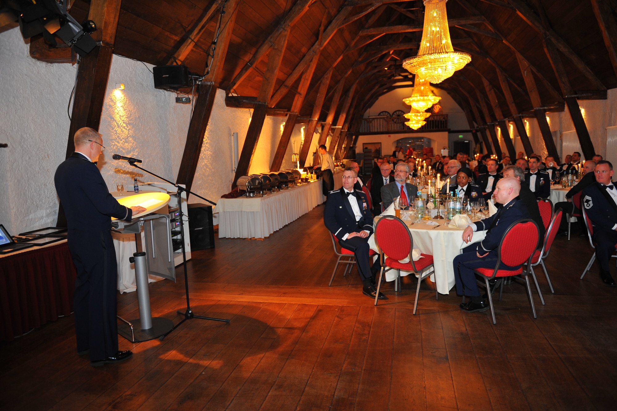 NIEDERWEIS, Germany – Col. Chris Weggeman, 52nd Fighter Wing commander, speaks to wing leadership and German civic leaders about the importance of building partnerships during a 52nd FW Honorary Commanders Banquet at Niederweis Castle here Feb. 24. The banquet is held to ceremoniously induct German civic leaders into the honorary commander program through a tradition of passing the 52nd FW guidon to the new honored commander. The program allows squadron, group and wing commanders to bolster and sustain partnerships with local leaders by working alongside one another to talk about and resolve community issues. (U.S. Air Force photo by Airman 1st Class Dillon Davis/Released)
