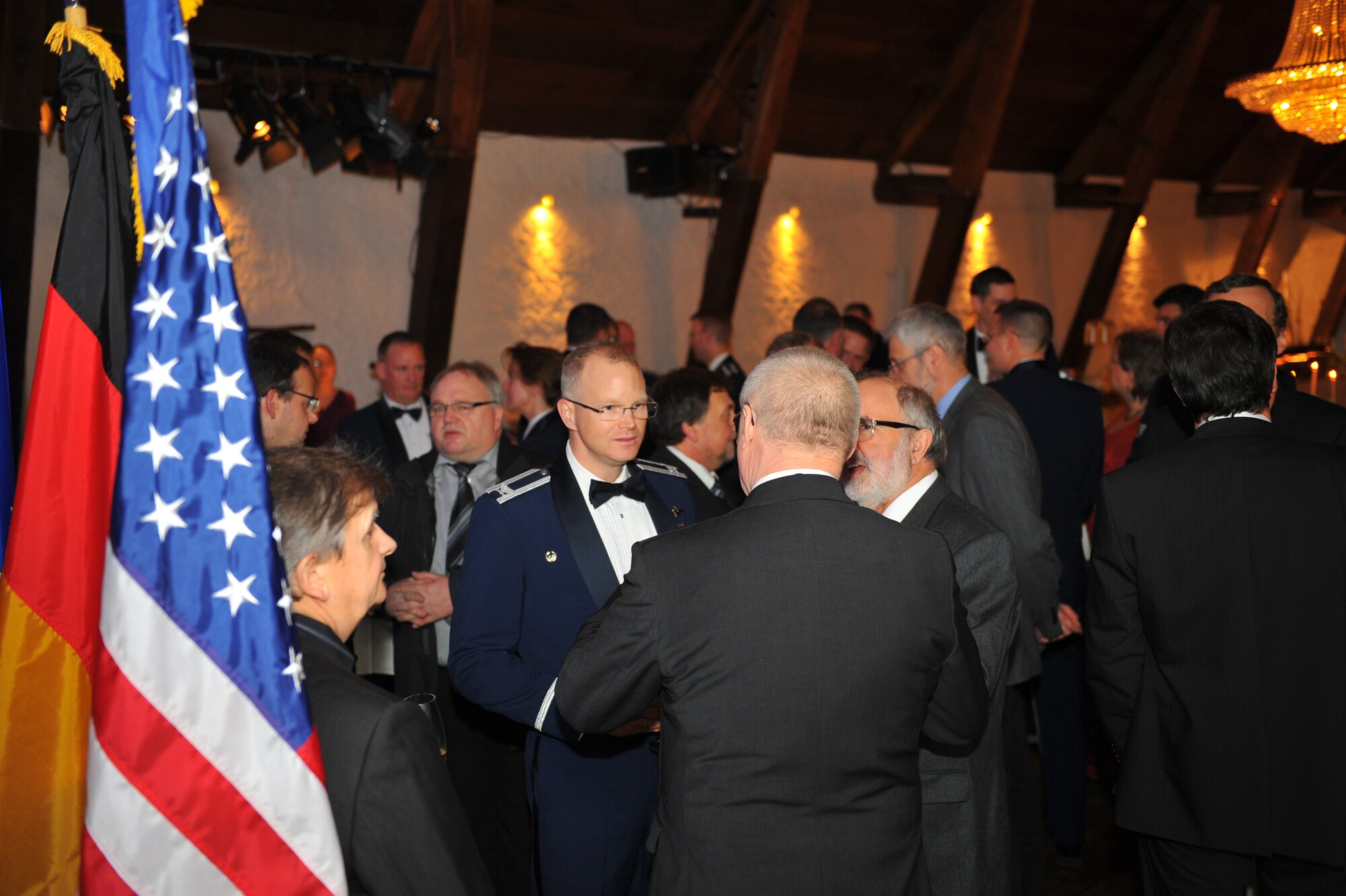 NIEDERWEIS, Germany – Spangdahlem Air Base leadership and German civic leaders socialize before the 52nd Fighter Wing Honorary Commanders Banquet at Niederweis Castle here Feb. 24. The banquet is held to ceremoniously induct German civic leaders into the honorary commander program through a tradition of passing the 52nd FW guidon to the new honored commander. The honorary commander program allows squadron, group and wing commanders to bolster and sustain partnerships with local leaders by working alongside one another to talk about and resolve community issues. (U.S. Air Force photo by Airman 1st Class Dillon Davis/Released)