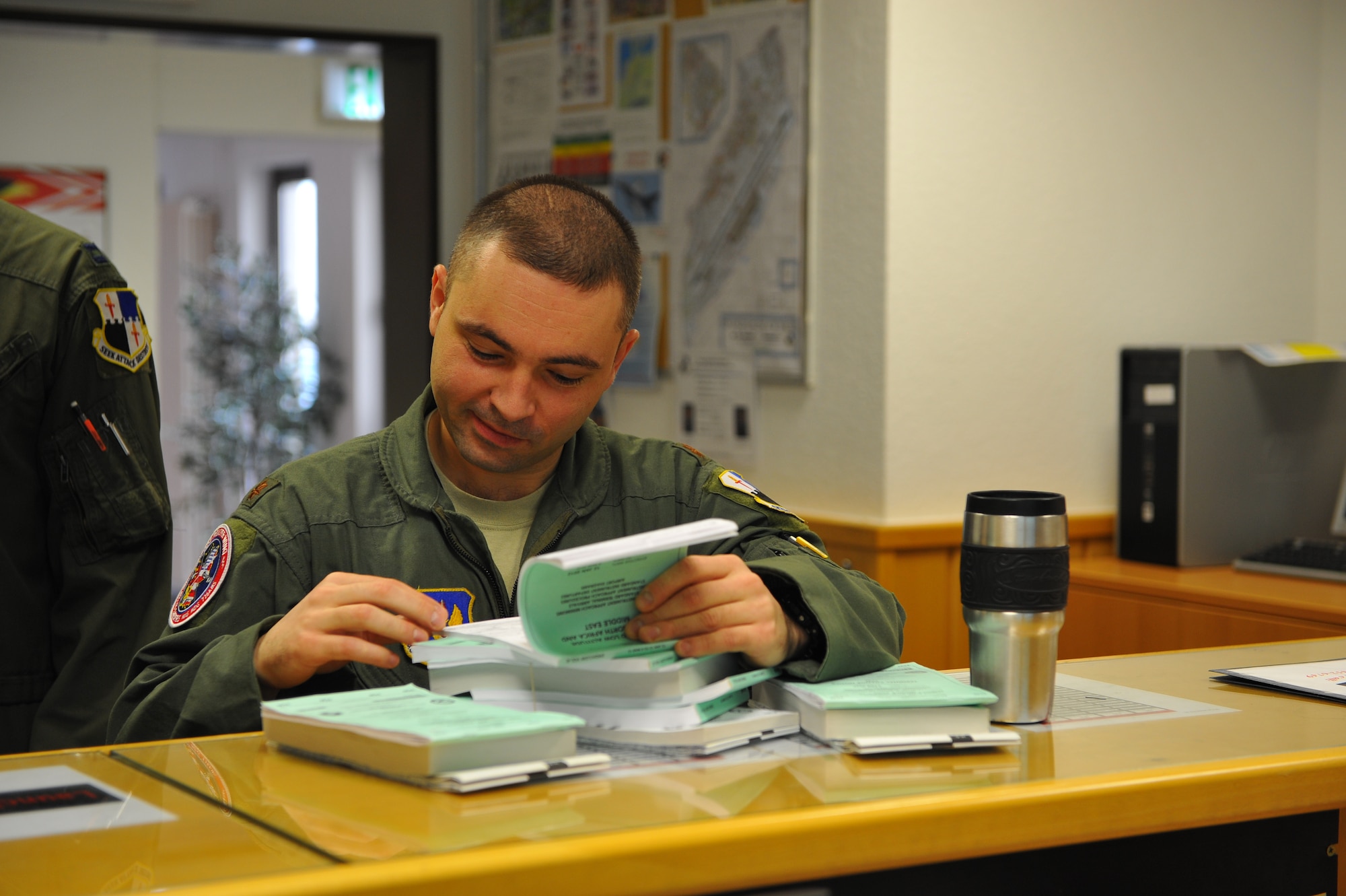 SPANGDAHLEM AIR BASE, Germany – Maj. Roman Pyatkov, 480th Fighter Squadron pilot, reads a flight publication before a pre-flight briefing inside Bldg. 108 here Feb. 21. Publications are used by pilots during flight training and missions to give pilots additional resources for various situations. Twelve Airmen work at the squadron’s operations desk and are responsible for coordinating with base operations, weather operations and aircraft maintenance to ensure flight operations run smoothly. The operations desk is also responsible for gathering and organizing flight information to help log flight hours and brief pilots before, during and after flights. (U.S. Air Force photo by Airman 1st Class Dillon Davis/Released)