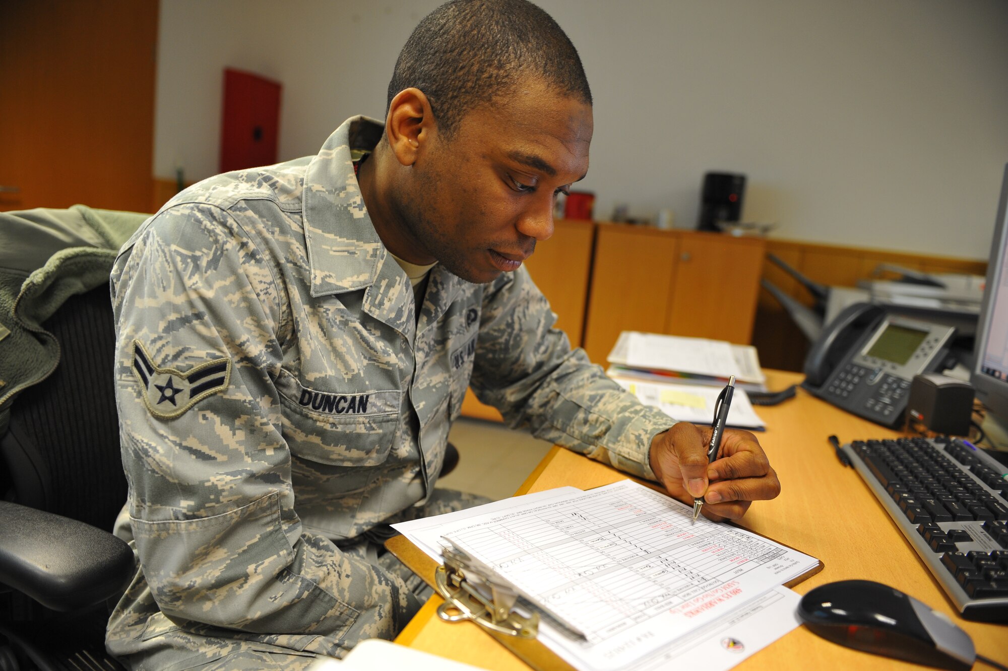 SPANGDAHLEM AIR BASE, Germany – Airman 1st Class Keith Duncan, 480th Fighter Squadron aviation resource management apprentice, verifies a checklist of who will and will not fly before a pre-flight briefing inside Bldg. 108 here Feb. 21. Twelve Airmen work at the squadron’s operations desk and are responsible for coordinating with base operations, weather operations and aircraft maintenance to ensure flight operations run smoothly. The operations desk is also responsible for gathering and organizing flight information to help log flight hours and brief pilots before, during and after flights. (U.S. Air Force photo by Airman 1st Class Dillon Davis/Released)