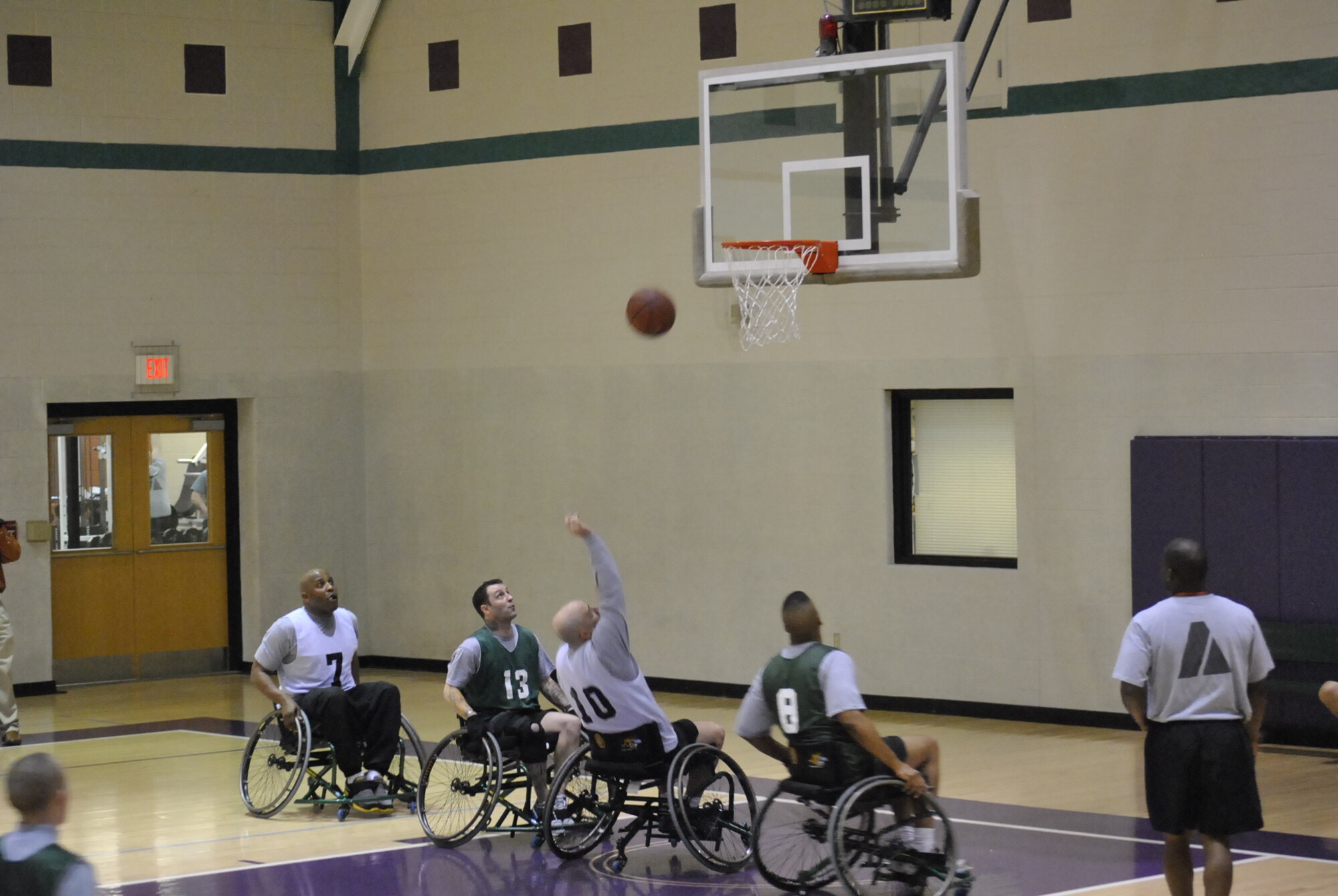 Headquarters Platoon's Tony Scheidenberger shoots a layup during wheel-chair basketball action of the Warrior Transition Unit’s Adaptive Sports Day recently at the McClellan Fitness Center at Fort Eustis, Va.  The mission of the WTU is to provide  care and case management for Soldiers in transition to establish the conditions for their healing, and to promote their timely return to the force or transition to civilian life. (Courtesy photo)