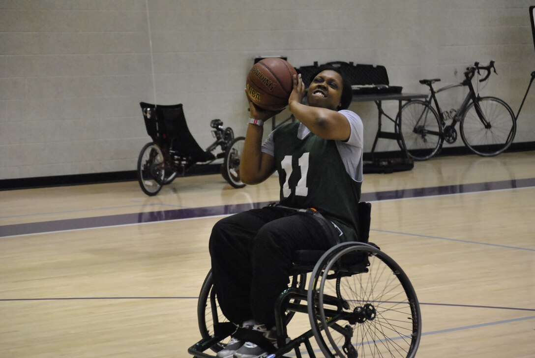 U.S. Army Sgt. Patricia Chatman of 3rd Platoon eyes the rim in her effort to net two points during wheel-chair basketball action of the Warrior Transition Unit’s Adaptive Sports Day recently at the McClellan Fitness Center at Fort Eustis, Va.  The mission of the WTU is to provide care and case management for Sildiers in transition to establish the conditions for their healing, and to promote their timely return to the force or transition to civilian life. (Photo by Selvin C. Walker)