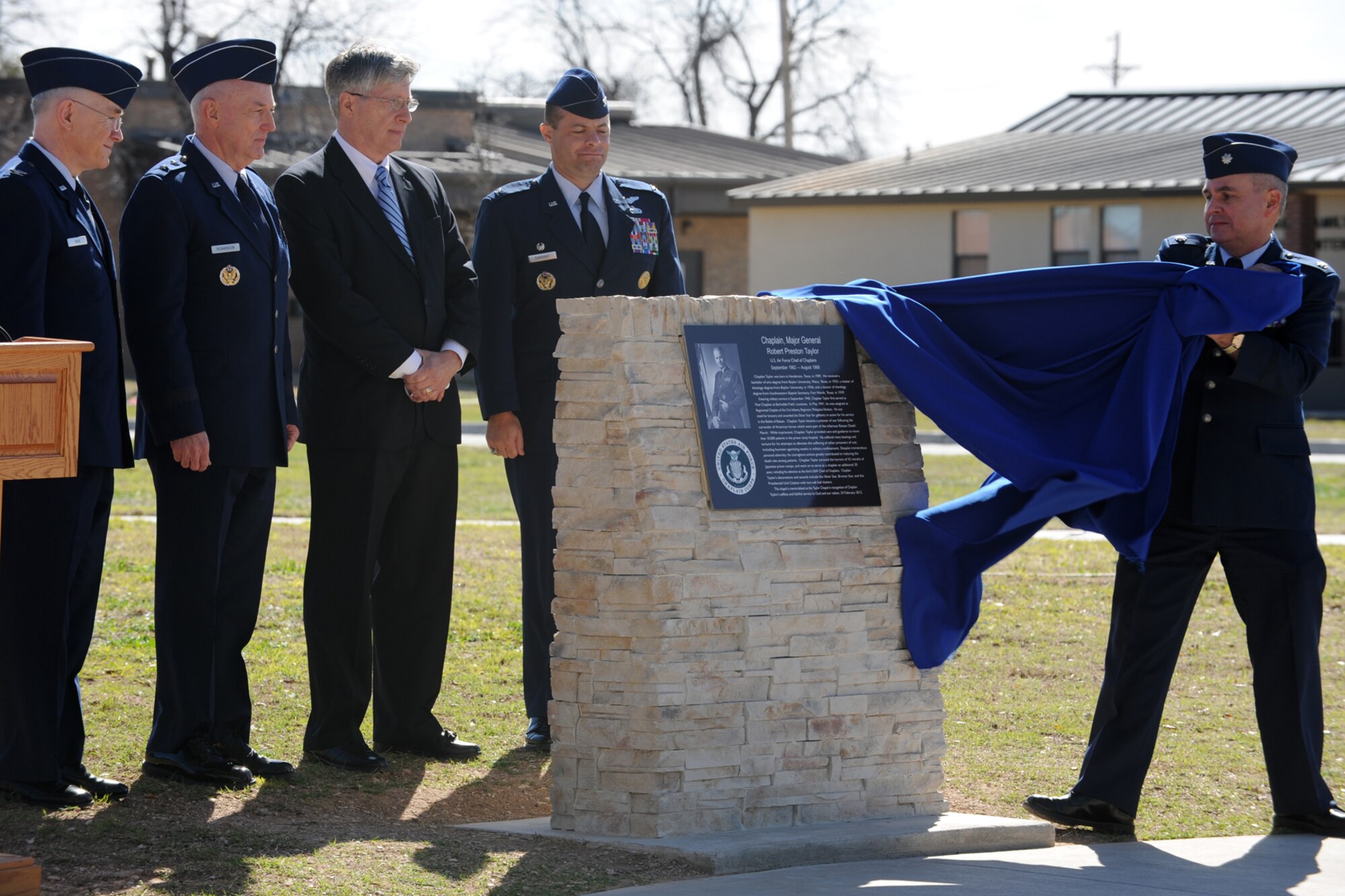GOODFELLOW AIR FORCE BASE, Texas -- Chaplain (Lt. Col.) Bruce Glover, 17th Training Wing, unveils the plaque during the dedication ceremony of the Taylor Chapel Feb. 24. The chapel was dedicated to Chaplain (Maj. Gen.) Robert Taylor who was the third U. S. Air Force Chief of Chaplains. (U.S. Air Force photo/Staff Sgt. Laura R. McFarlane)