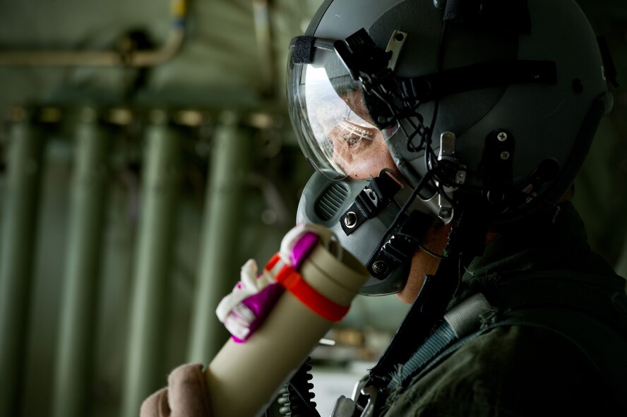 U.S. Air Force Master Sgt. Malcolm Mercado, 40th Airlift Squadron load master, prepares to throw a wind sonde out a C-130J Hercules Feb. 23, 2012, at Dyess Air Force Base, Texas. This wind sonde device, part of the joint precision air drop system, is released at high altitudes over a drop zone to measure the wind prior to an actual cargo drop. This allows C-130 aircrews to drop cargo at safe distances from enemy fire. (U.S. Air Force photo by Staff Sgt. Jonathan Snyder/Released)                           