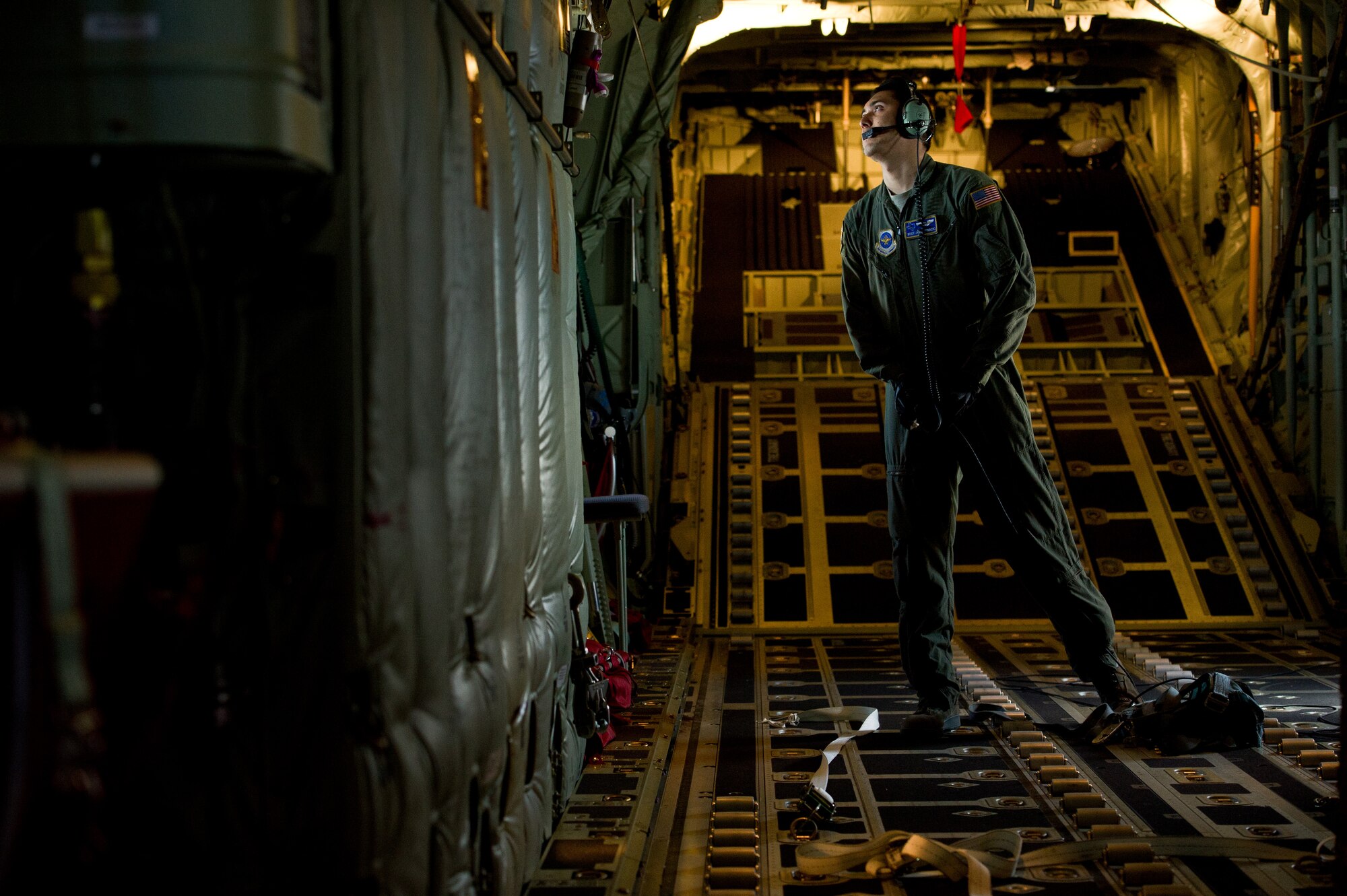 U.S. Air Force Staff Sergeant Jason Ignacio, 40th Airlift Squadron load master, watches other C-130J Hercules during unilateral training mission on a joint precision air drop system, (JPADS) at almost 10,000 feet Feb. 22, 2012, at Dyess Air Force Base, Texas. JPADS uses global positioning system to guide the cargo accurately to the drop zone while the aircraft is safely out of reach from enemy fire. (U.S. Air Force photo by Staff Sgt. Jonathan Snyder/Released)
