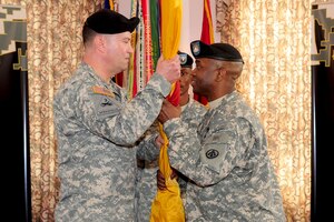 The 597th Transportation Brigade Command Sgt. Major Allen B. Offord Jr., right, passes the guidon to Col. Charles R. Brown, 597th commander, during a relinquishment of responsibility ceremony at Fort Eustis, Va., Feb. 24, 2012. Master Sgt. Cedric L. Richardson will assume responsibility at a later date, after he has gained the rank of sergeant major.  (U.S. Air Force photo by Staff Sgt. Ashley Hawkins/Released)