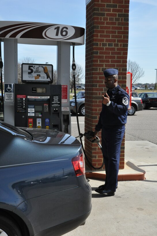 Master Sgt. Max Walker, 1st Operations Group first sergeant, marshals a car into place for a free tank of gas at the shoppette on base Feb. 27, 2012. The First Sergeant’s Council at Langley Air Force Base, Va., gave away $1000 in free gas to junior enlisted personnel as part of their Random Acts of Kindness Program. (U.S. Air Force Photo by Tech. Sgt. Randy Redman/Released)