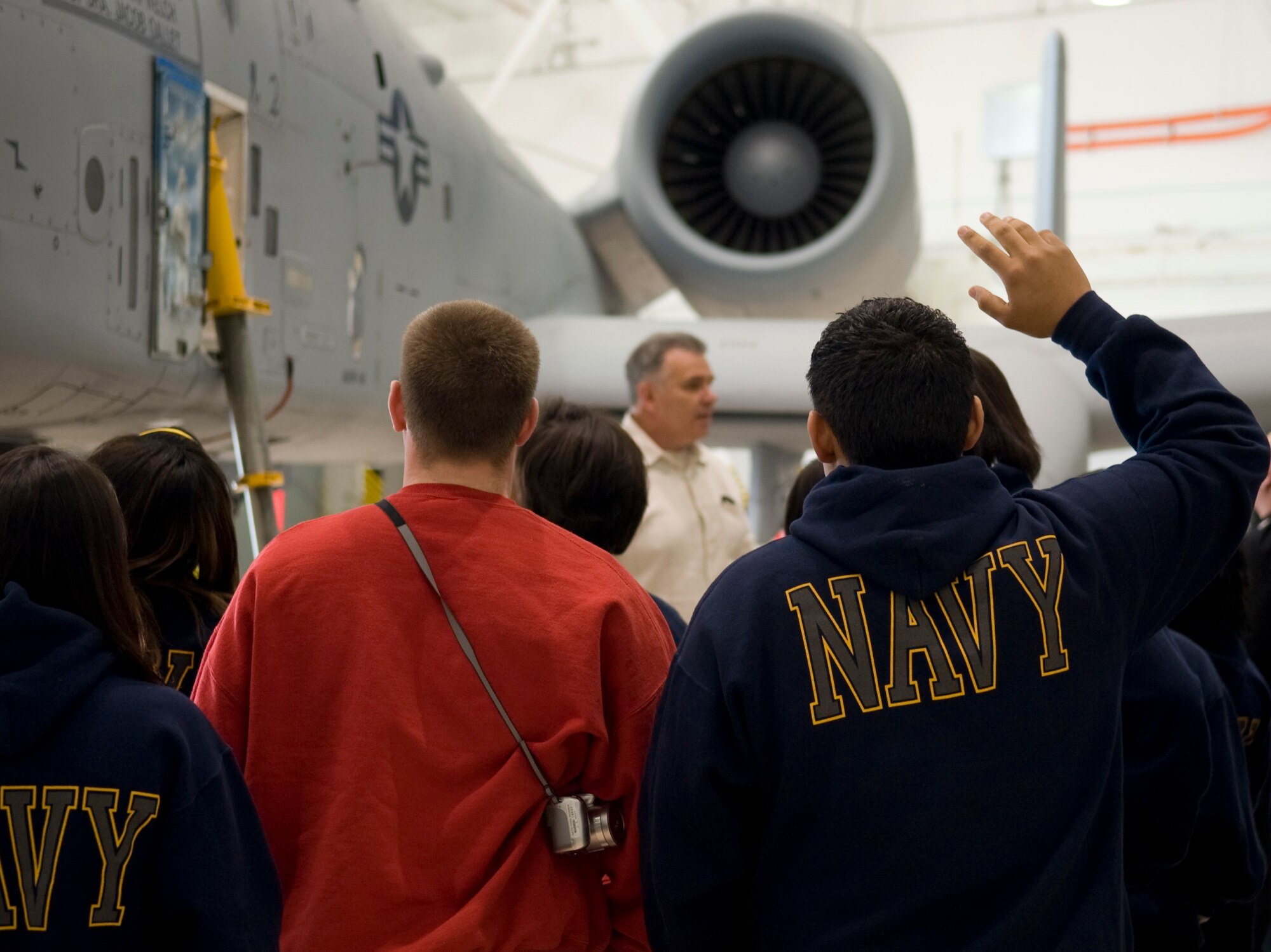 A Navy Junior Reserve Officers' Training Corps cadet raises his hand to ask Master Sgt. Greg Steele, 307th Bomb Wing Public Affairs, a question about the A-10 Thunderbolt II on Barksdale Air Force Base, La., Feb. 24. The A-10, which is a one pilot aircraft, has been in service for more than 35 years. (U.S. Air Force photo/Airman 1st Class Benjamin Gonsier)(RELEASED)
