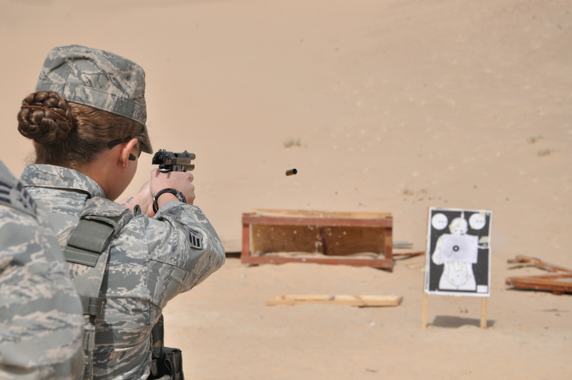 SOUTHWEST ASIA -- Senior Airman Jessika Hill, 332nd Expeditionary Security Forces Squadron member, fires an M-9 pistol Feb. 24, 2012 at an undisclosed location in Southwest Asia. Hill and her team members went through more than 2,000 rounds of ammunition during firing training. Hill is deployed from Kirtland Air Force Base, N.M., and is a native of Baltimore. (U.S. Air Force photo by Senior Airman Melanie Holochwost/Released)