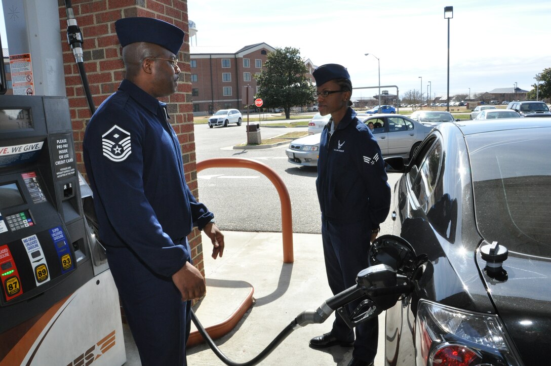 Master Sgt. Max Walker, 1st Operations Group first sergeant, right, pumps a free tank of gas for Senior Airman Shalayne Dulan, 1st Fighter Wing Knowledge Operations manager, at the gas station on base Feb. 27, 2012. The First Sergeant’s Council at Langley Air Force Base, Va., gave away $1000 in free gas to junior enlisted personnel as part of their Random Acts of Kindness Program. (U.S. Air Force Photo by Tech. Sgt. Randy Redman/Released)