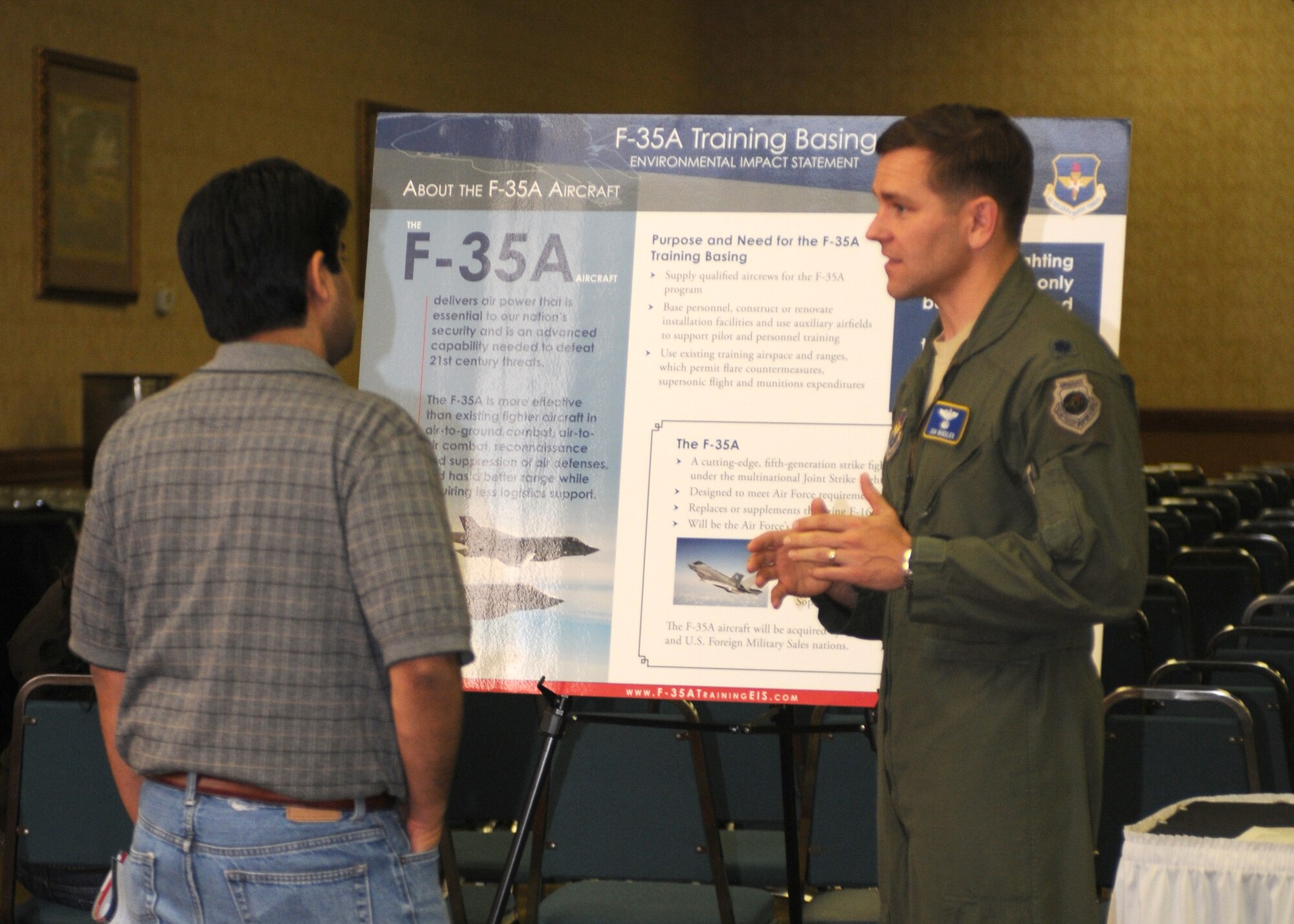 Lt. Col. Jon Wheeler, an F-35 instructor pilot assigned to Eglin Air Force Base, Fla., discusses the aircraft’s capabilities with an interested member of the Tucson community Feb. 22 at a public hearing at the Holiday Inn near Tucson International Airport. Officials from the U.S. Air Force, Air Education and Training Command, and the 162nd Fighter Wing were available to answer questions and encourage public comment on the proposed basing of an F-35A Pilot Training Center at the Airport.  (U.S. Air Force photo/1st Lt. Angela Walz)