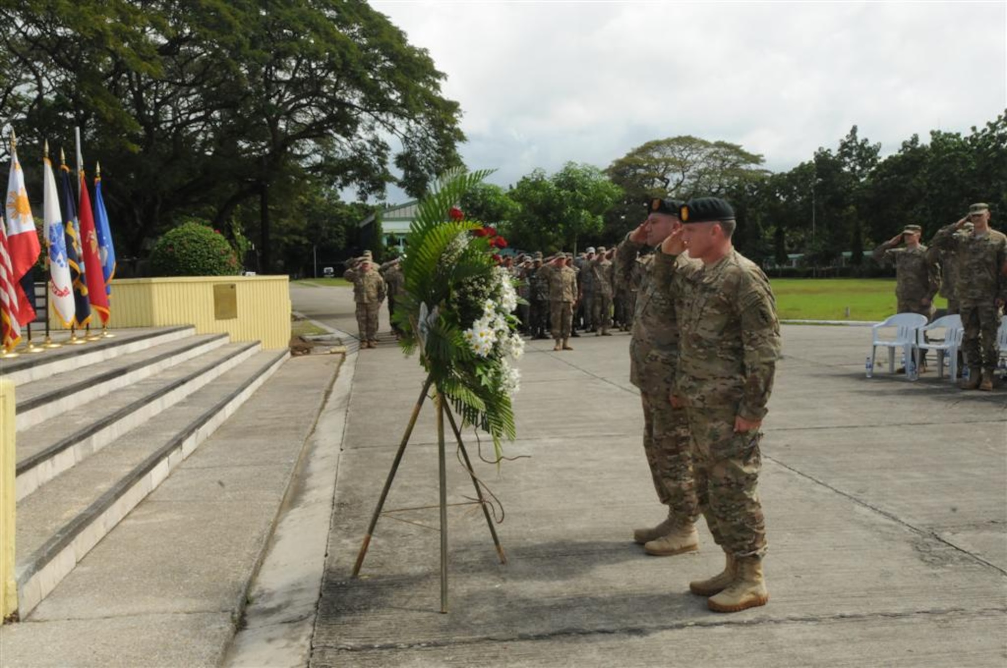 U.S. Army Col. Fran Beaudette, Commander of Joint Special Operations Task Force – Philippines (foreground,) and Command Sgt. Maj. Frank Gilliand lay a wreath at the base of a memorial statue during a ceremony commemorating the crash of “Wild 42.”  Ten members of JSOTF-P died when their US MH-47E Chinook helicopter went down in the Bohol Sea while returning from a mission in Basilan in 2002. (U.S. Air Force photo by Major Darrick B. Lee/Released)
