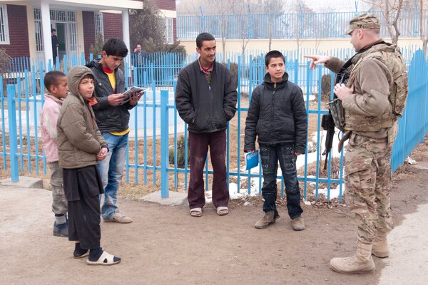 KABUL, Afghanistan — Air Force Maj. Mike Brannon from the U.S. Army Corps of Engineers Afghanistan Engineer District North speaks in Dari to a group of orphans while dropping off donations on Jan. 14, 2012. U.S. Army Corps of Engineers employees distributed two dozen boxes of donated jackets, hats, gloves and other winter clothes to the large orphanage.