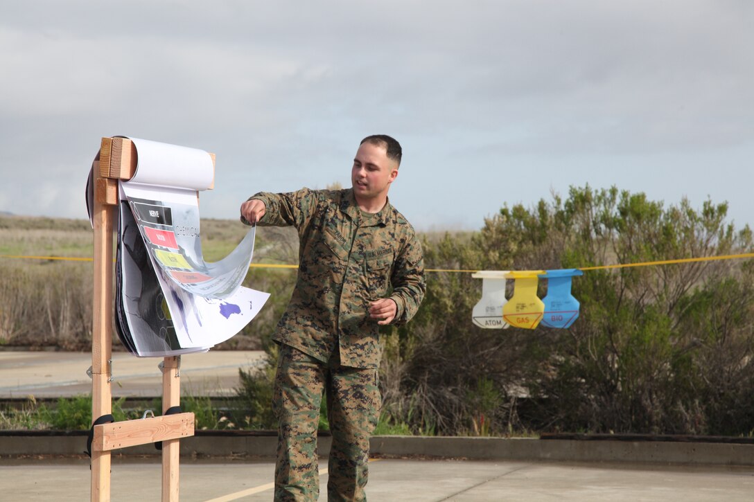 Sergeant Travis Tabor, chemical biological radiological nuclear instructor, Command Element, 15th Marine Expeditionary Unit, teaches a class during an Individual Protective Equipment Confidence Exercise at the 33 Area gas chamber, Feb. 28. Marines and sailors from the 15th MEU were completing annual training that built confidence in their equipment and taught the servicemembers survival techniques in case of a CBRN threat.
