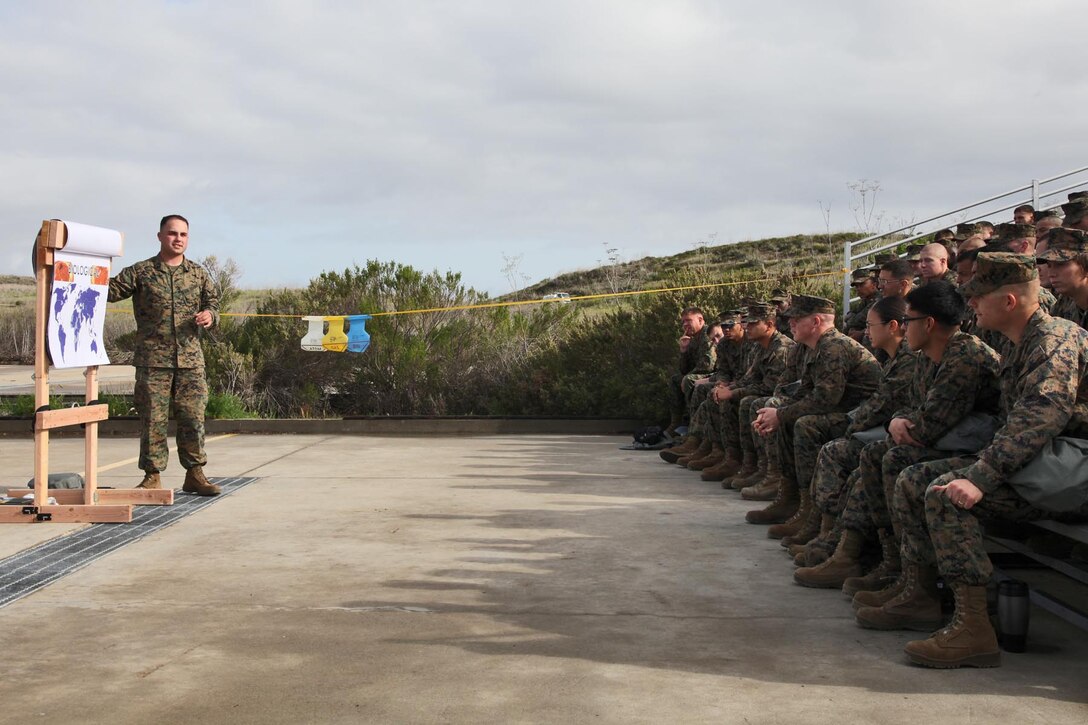 Sergeant Travis Tabor, chemical biological radiological nuclear instructor, Command Element, 15th Marine Expeditionary Unit, teaches a class during an Individual Protective Equipment Confidence Exercise at the 33 Area gas chamber, Feb. 28. Marines and sailors from the 15th MEU were completing annual training that built confidence in their equipment and taught the servicemembers survival techniques in case of a CBRN threat.